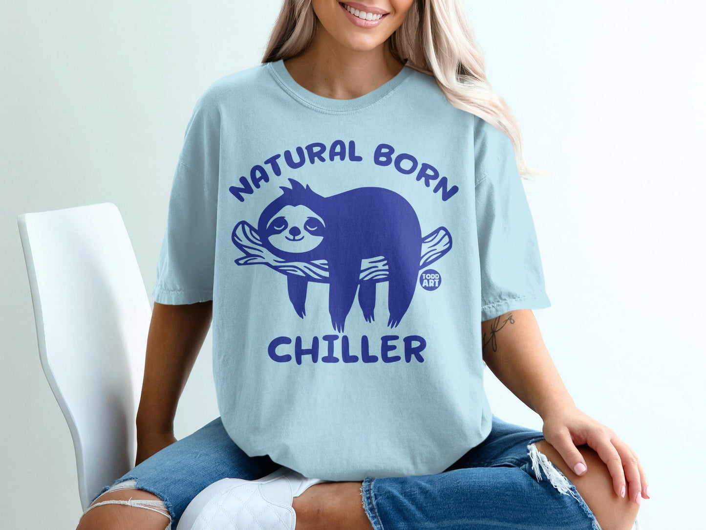Light blue t-shirt with a blue sloth design and text "Natural Born Chiller".