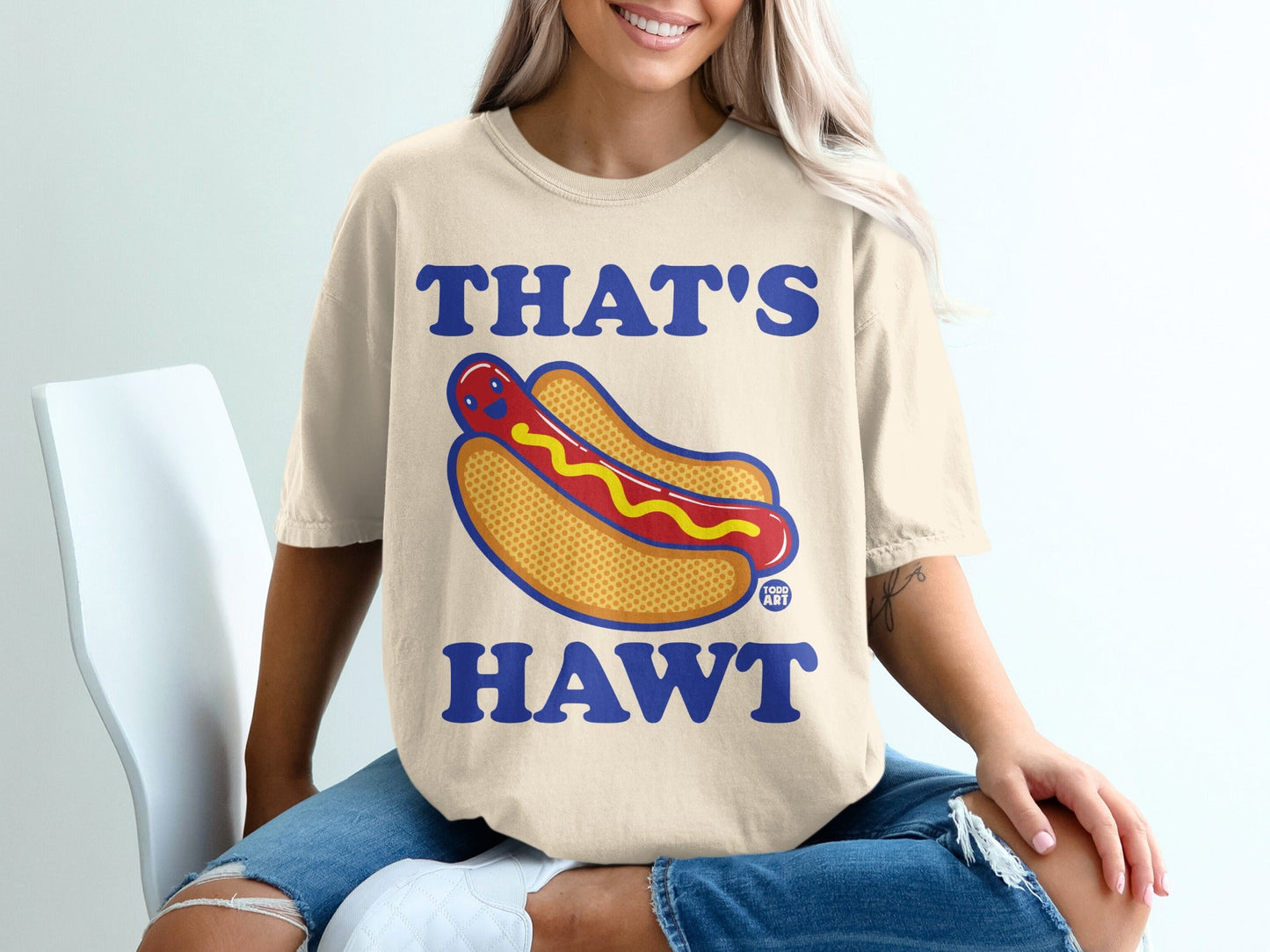 Cream t-shirt with cartoon hot dog and text "THAT'S HAWT".