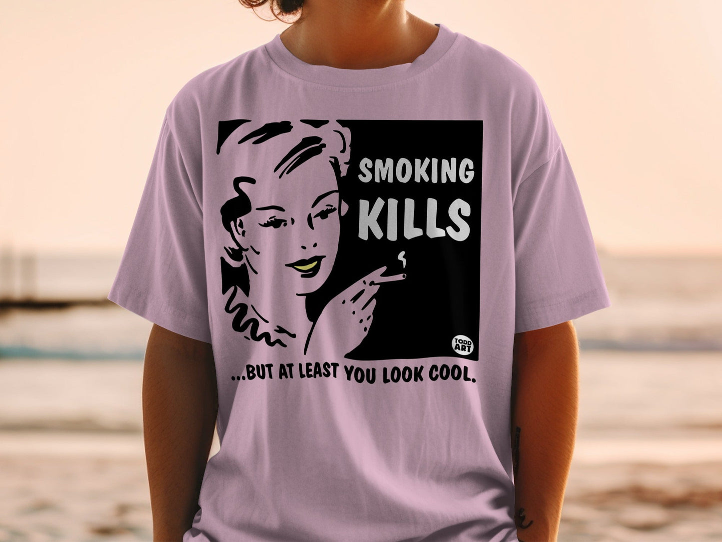 T-shirt with a retro graphic of a woman smoking, reading "SMOKING KILLS...BUT AT LEAST YOU LOOK COOL."