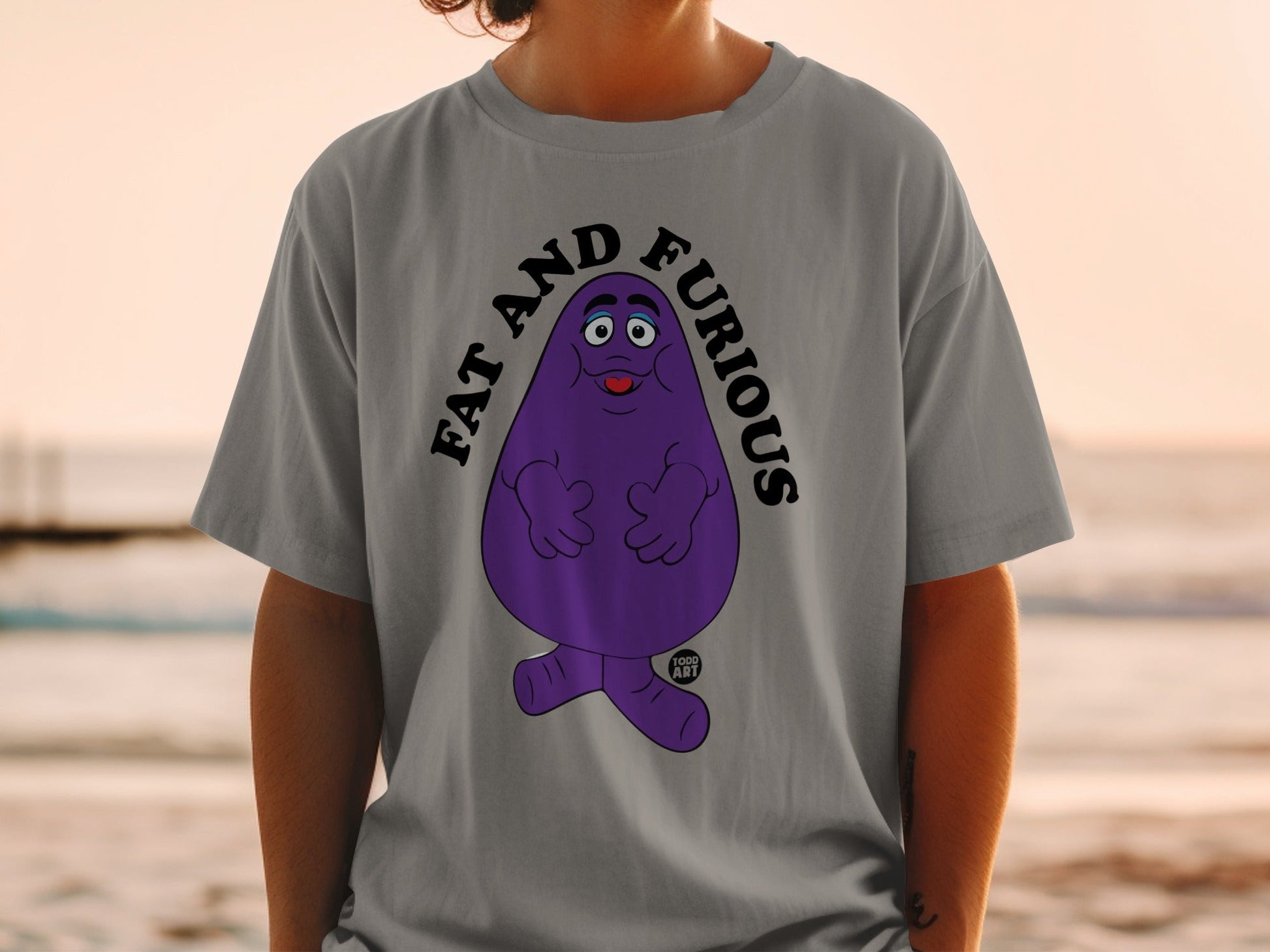 Purple character with "FAT AND FURIOUS" text on a grey t-shirt.