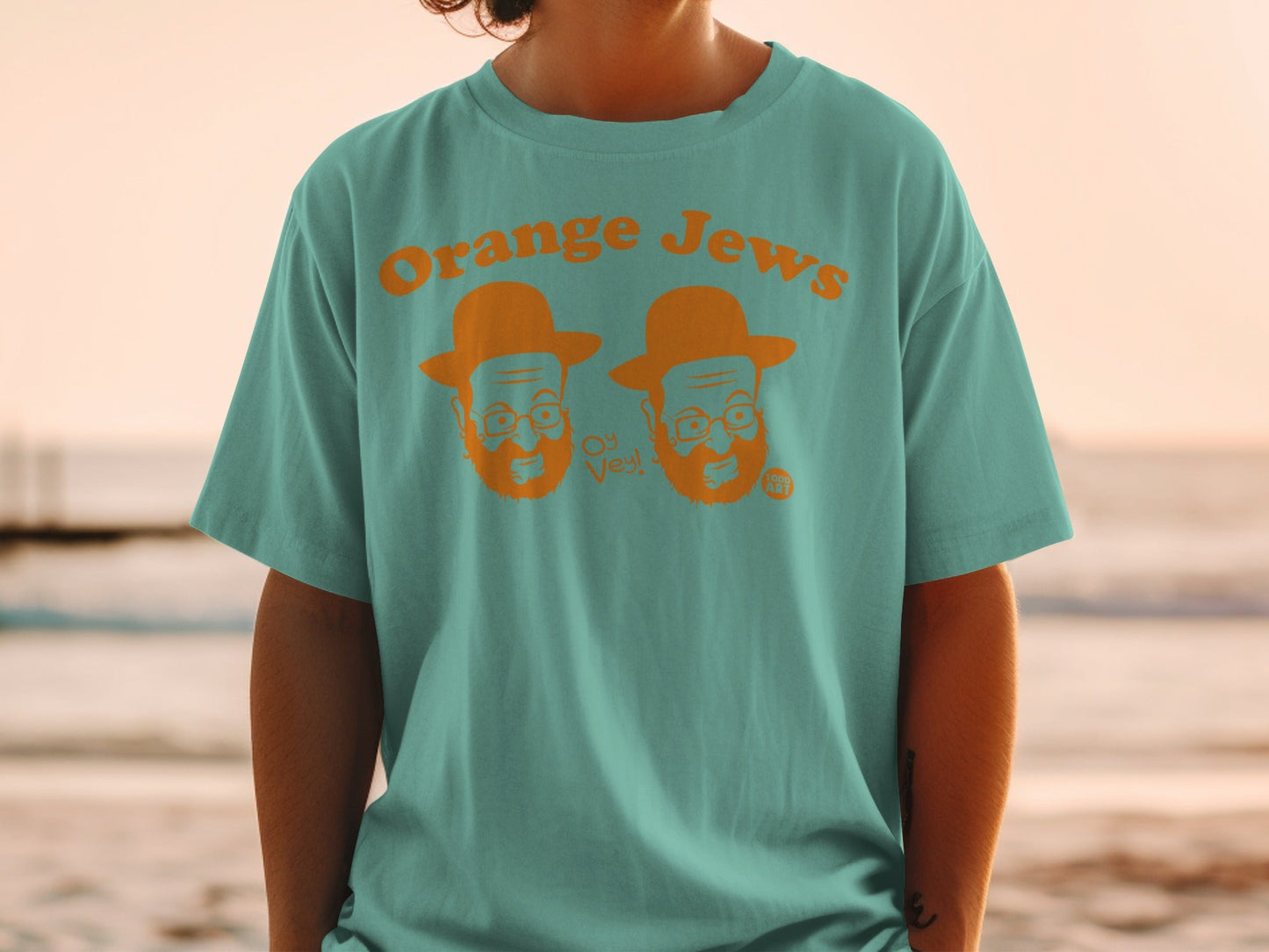 Teal t-shirt with cartoon orange Jewish men saying "Oy Vey!"