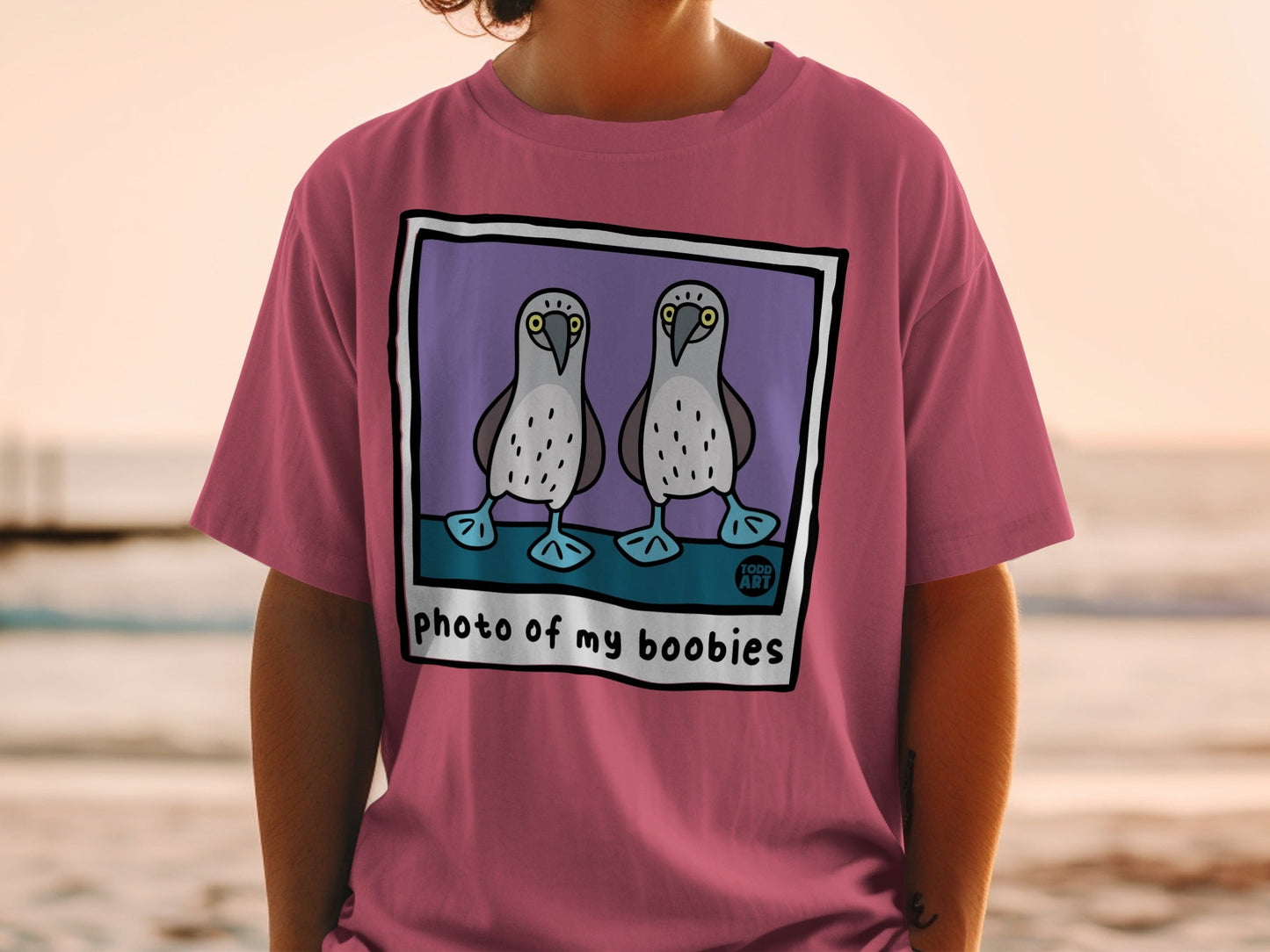 Illustration of two boobies on a t-shirt with text "photo of my boobies".
