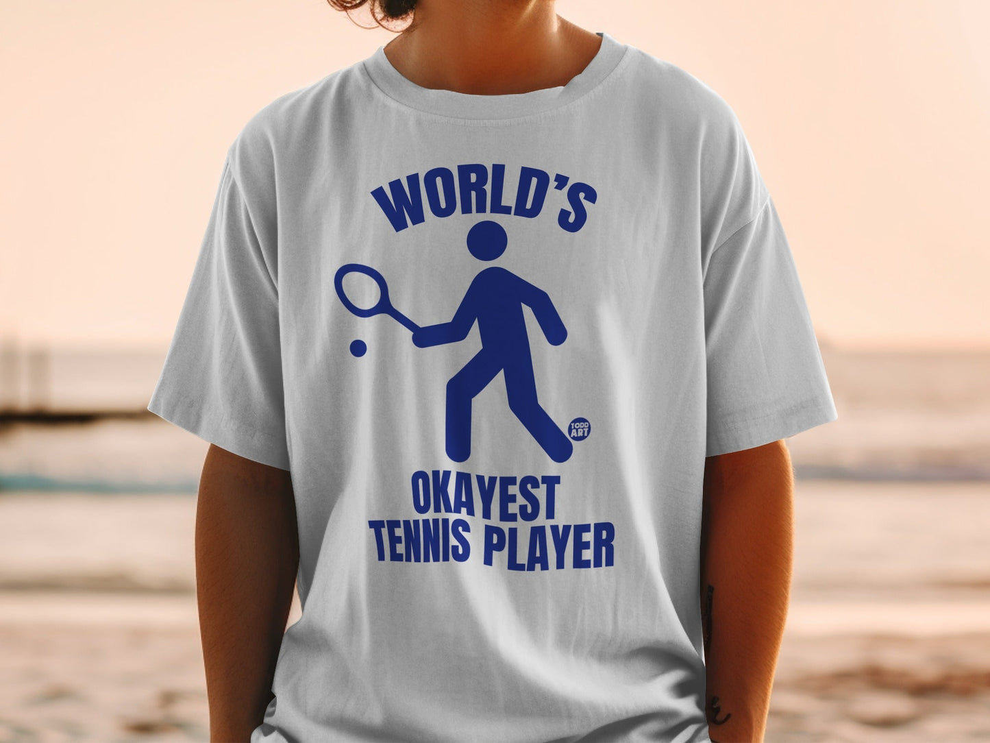 White t-shirt with blue text and graphic of a tennis player.