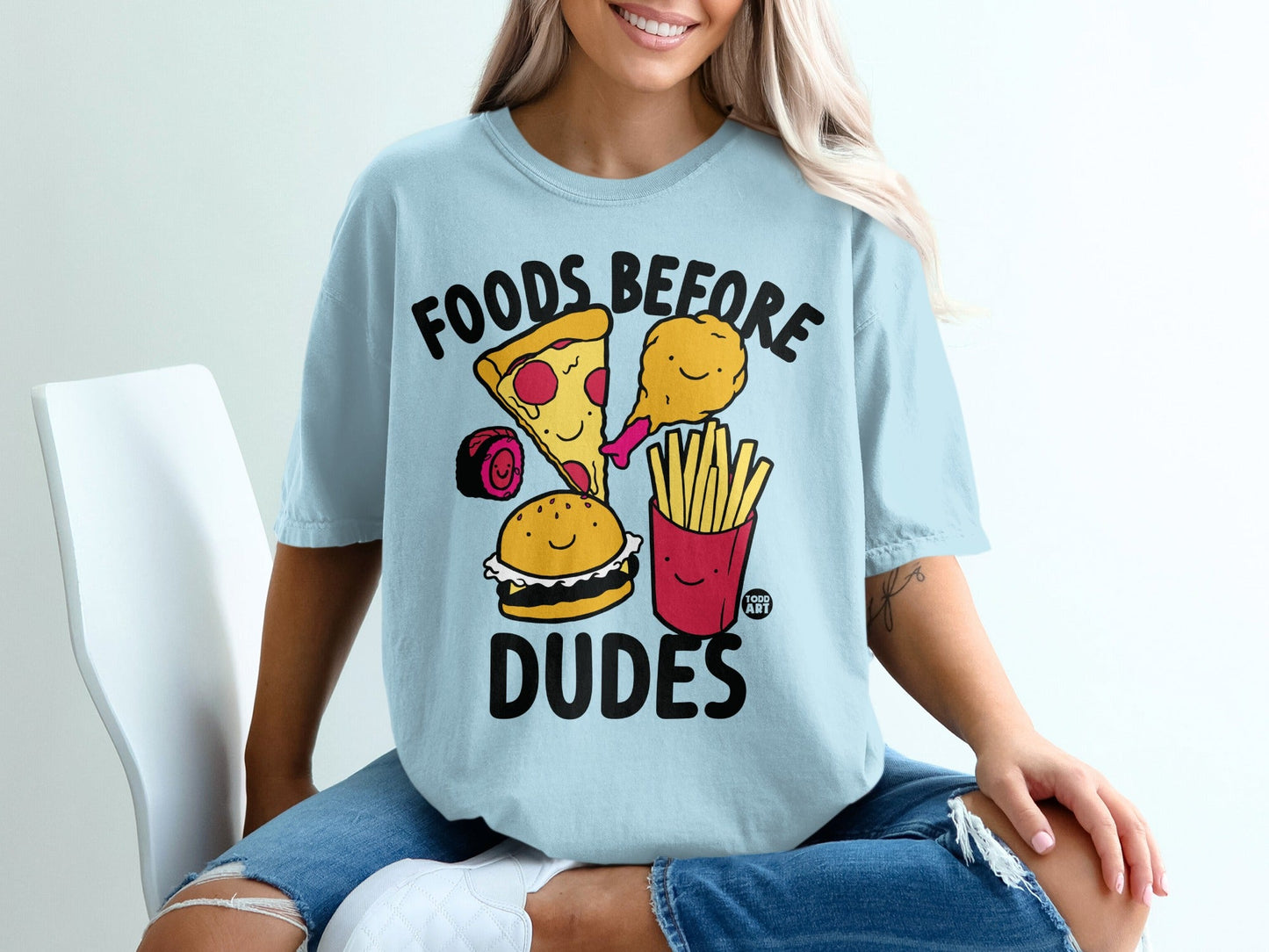 Light blue t-shirt with cartoon foods: pizza, burger, fries, chicken drumstick.