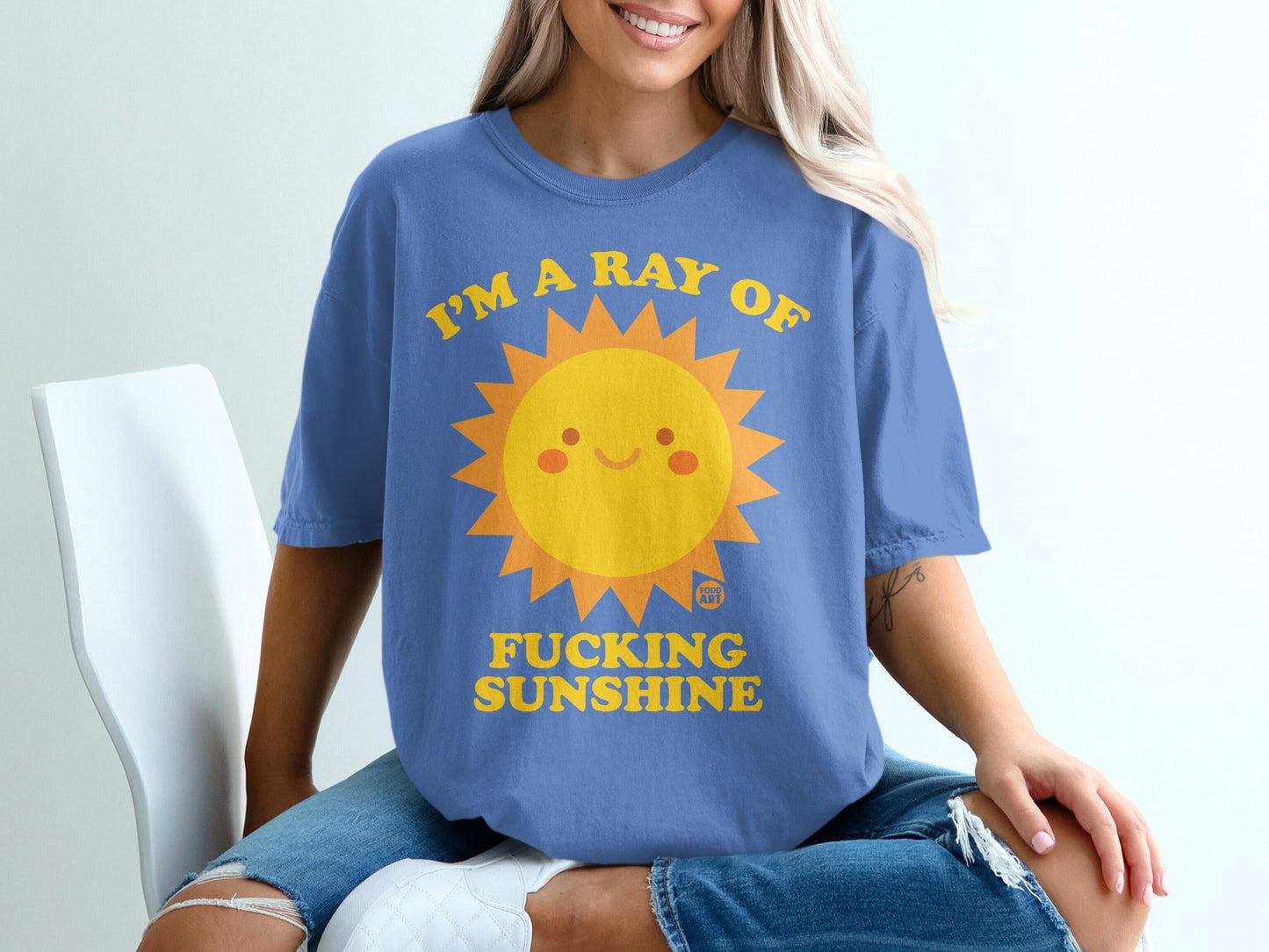 Blue t-shirt with a smiling sun graphic and "I'm a ray of FUCKING SUNSHINE" text.