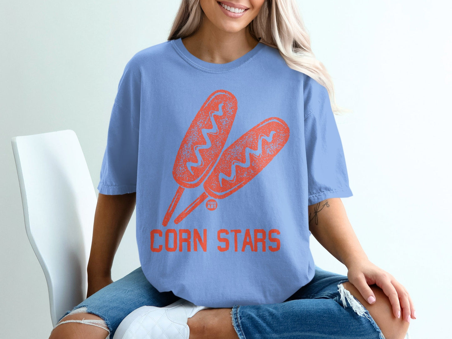 Blue t-shirt with two orange corn dog graphic and "CORN STARS" text.