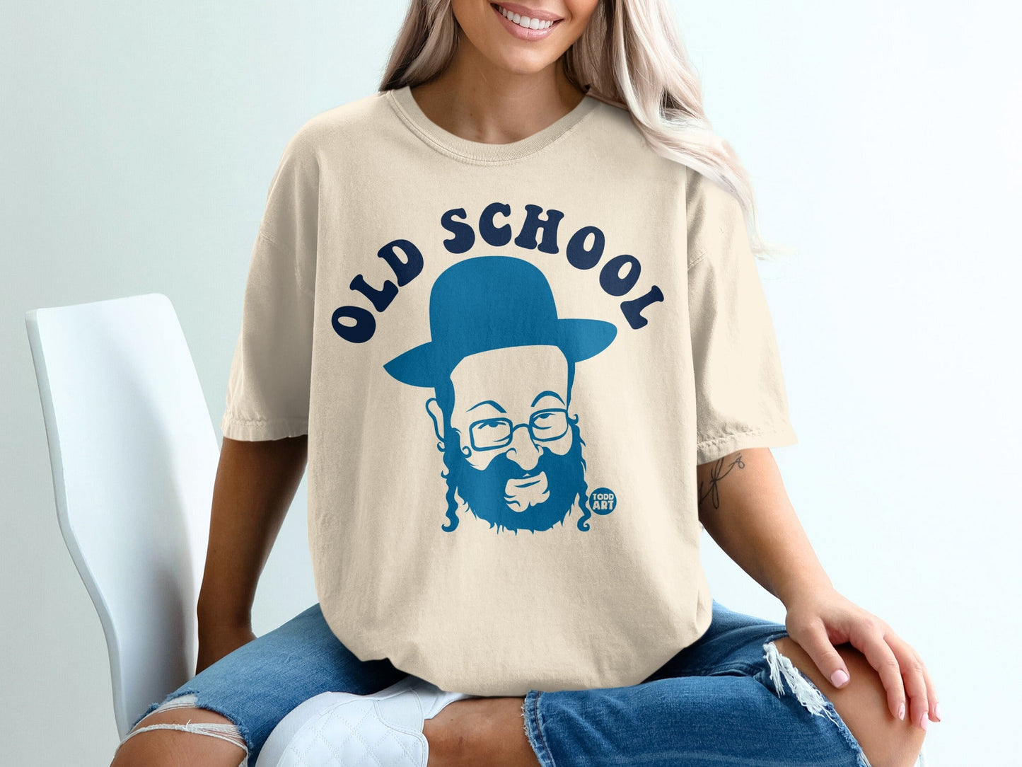 Cream t-shirt with a blue graphic of a bearded man in a hat and "OLD SCHOOL" text.
