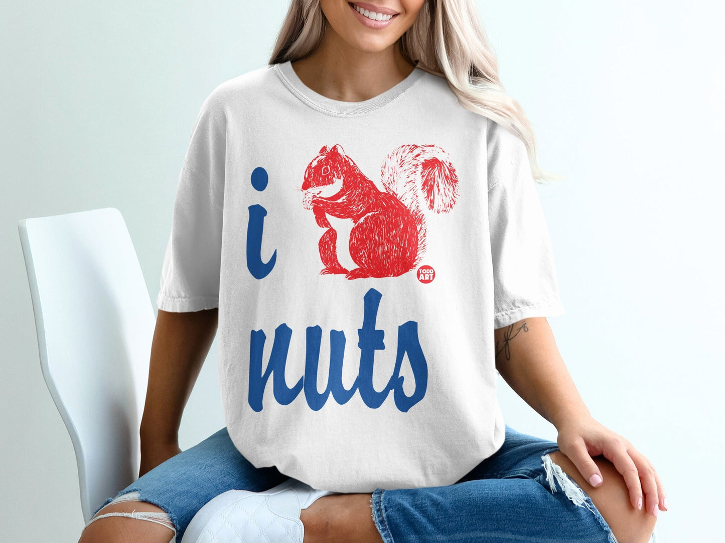 White t-shirt with "i nuts" and red squirrel graphic.