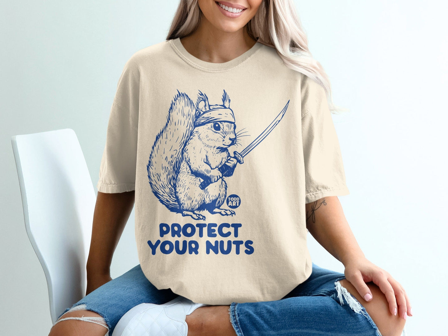 Squirrel wearing a bandana holding a sword with text "PROTECT YOUR NUTS".