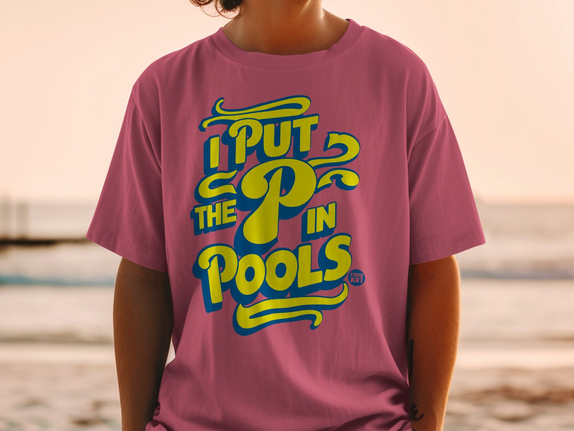 Pink t-shirt with yellow text "I PUT THE P IN POOLS".