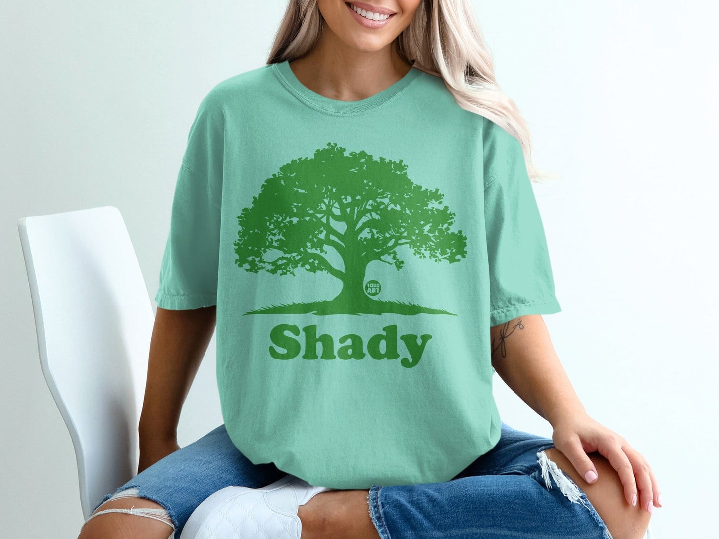 Green t-shirt with a large tree and "Shady" text.