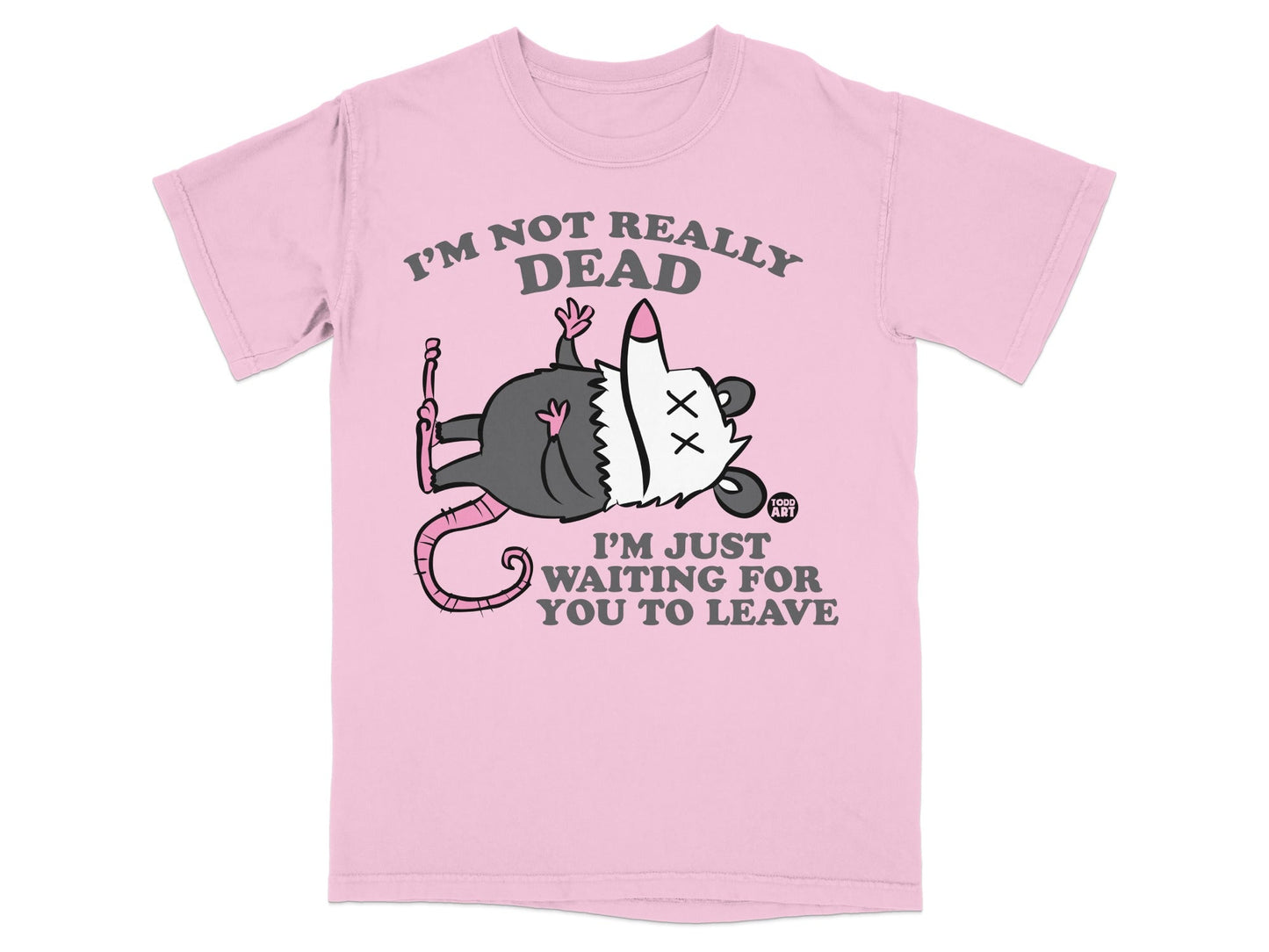 Pink t-shirt with a cartoon opossum and text: "I'm not really dead. I'm just waiting for you to leave."