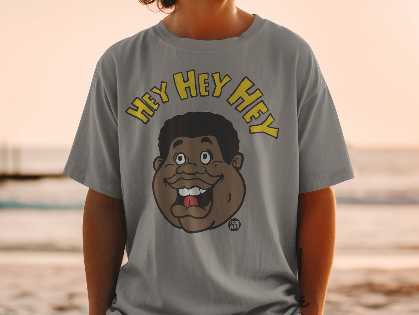 T-shirt with a cartoon of a man's face saying "Hey Hey Hey."