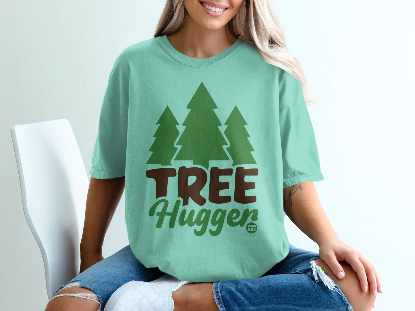 Teal t-shirt with three green trees and "TREE Hugger" text.