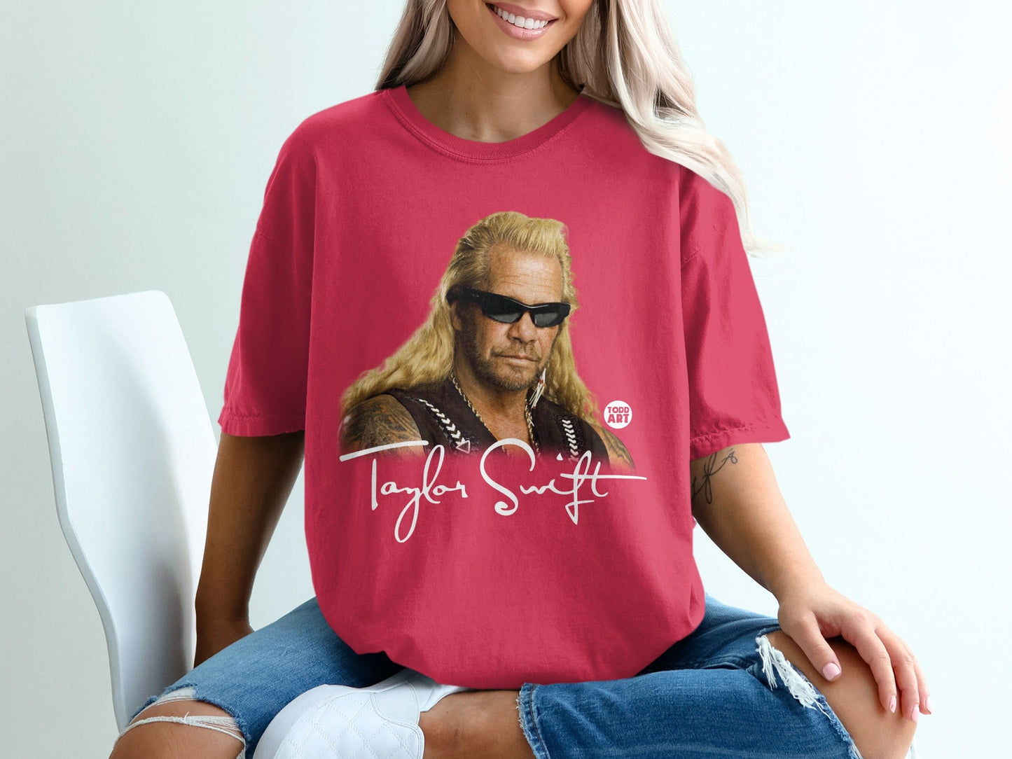 Red t-shirt with Dog the Bounty Hunter and Taylor Swift printed graphic.