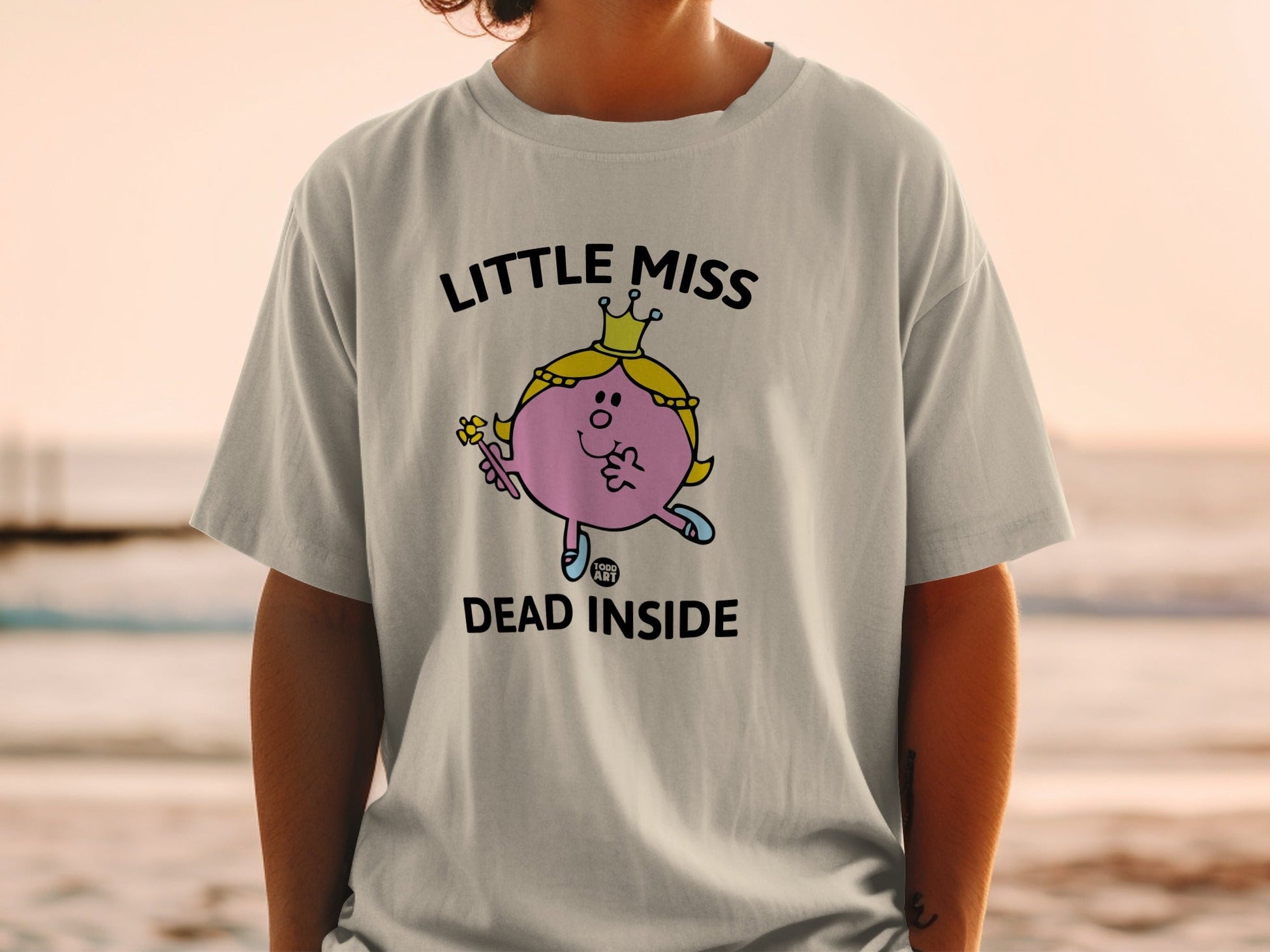 Little Miss character wearing crown, holding wand, text "LITTLE MISS DEAD INSIDE".