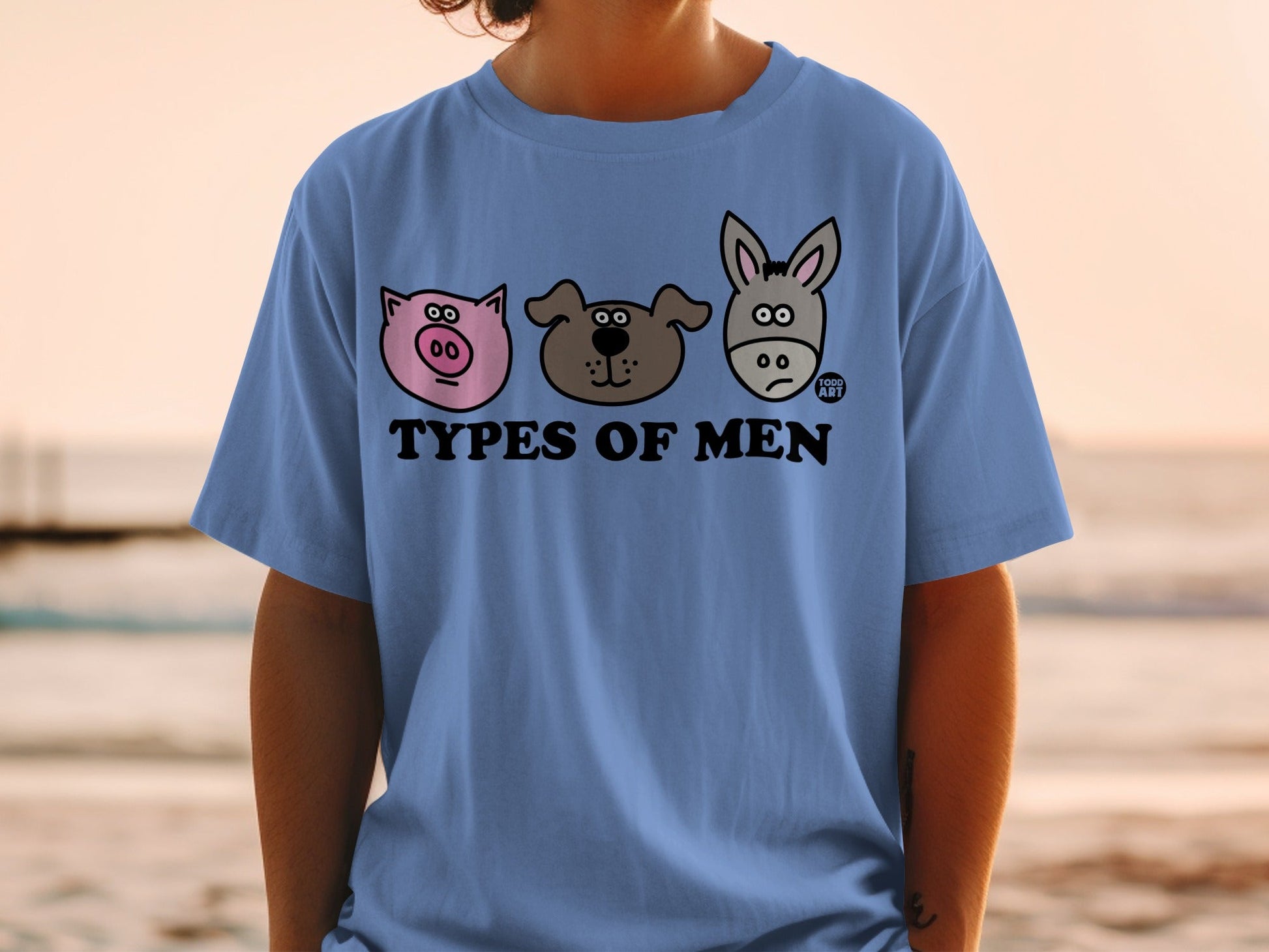 Blue t-shirt with cartoon pig, dog, and donkey heads and "Types of Men" text.