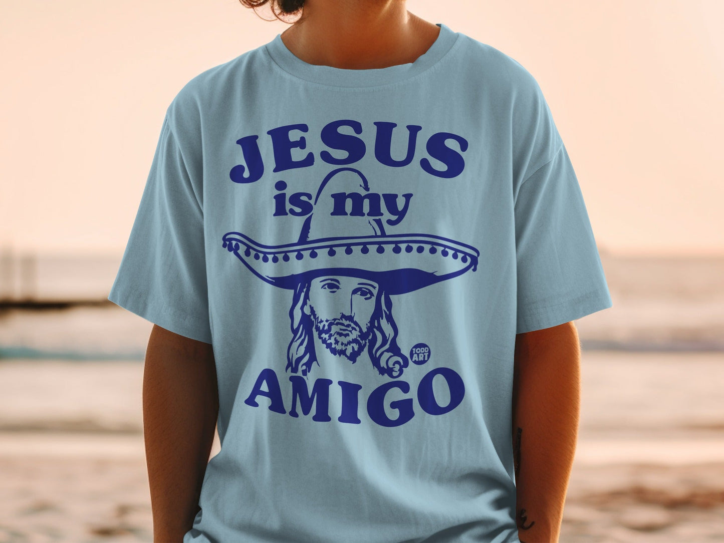 Light blue t-shirt with Jesus wearing a sombrero, text "Jesus is my amigo".