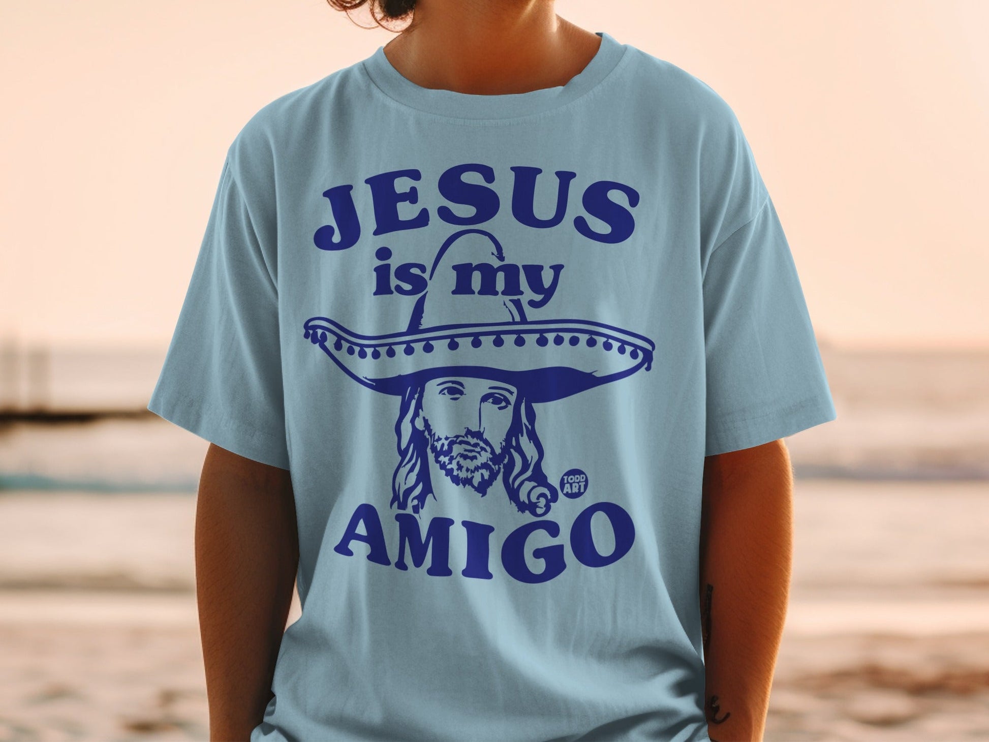 Light blue t-shirt with Jesus wearing a sombrero, text "Jesus is my amigo".