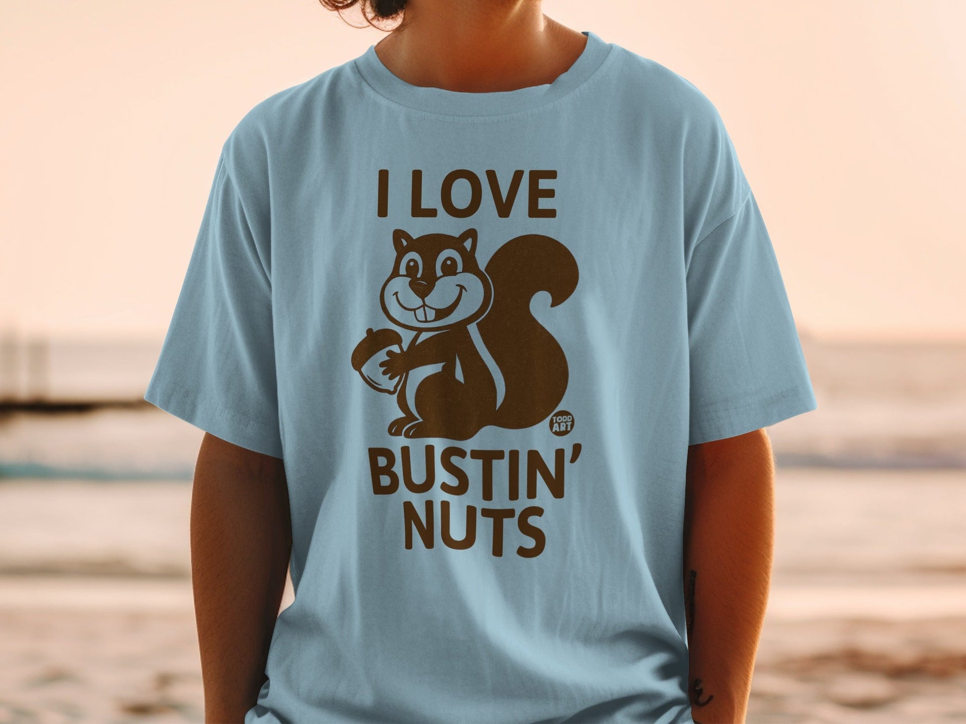 Light blue t-shirt with cartoon squirrel and "I LOVE BUSTIN' NUTS" text.