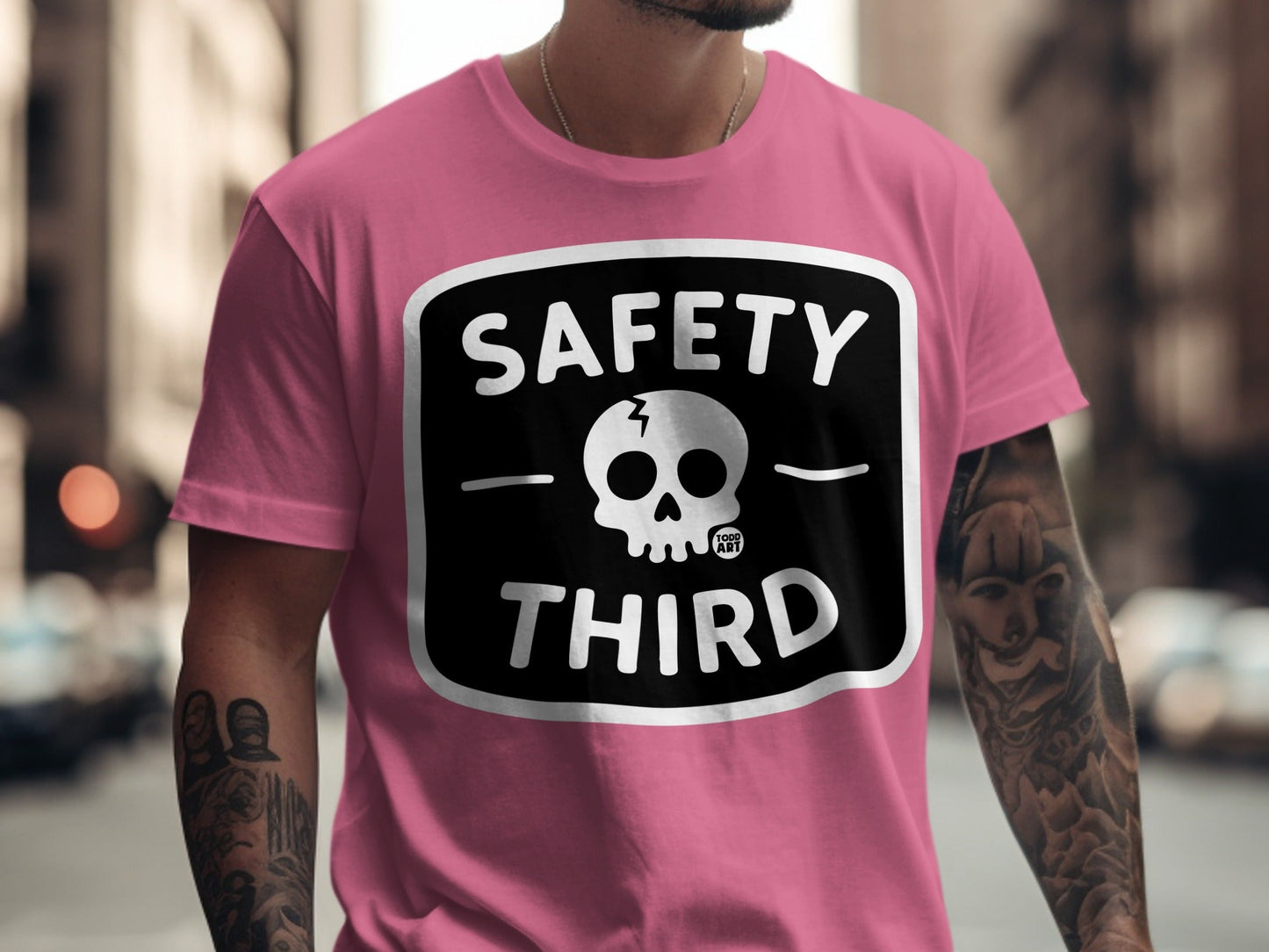 Pink t-shirt with black "SAFETY THIRD" text and skull logo.