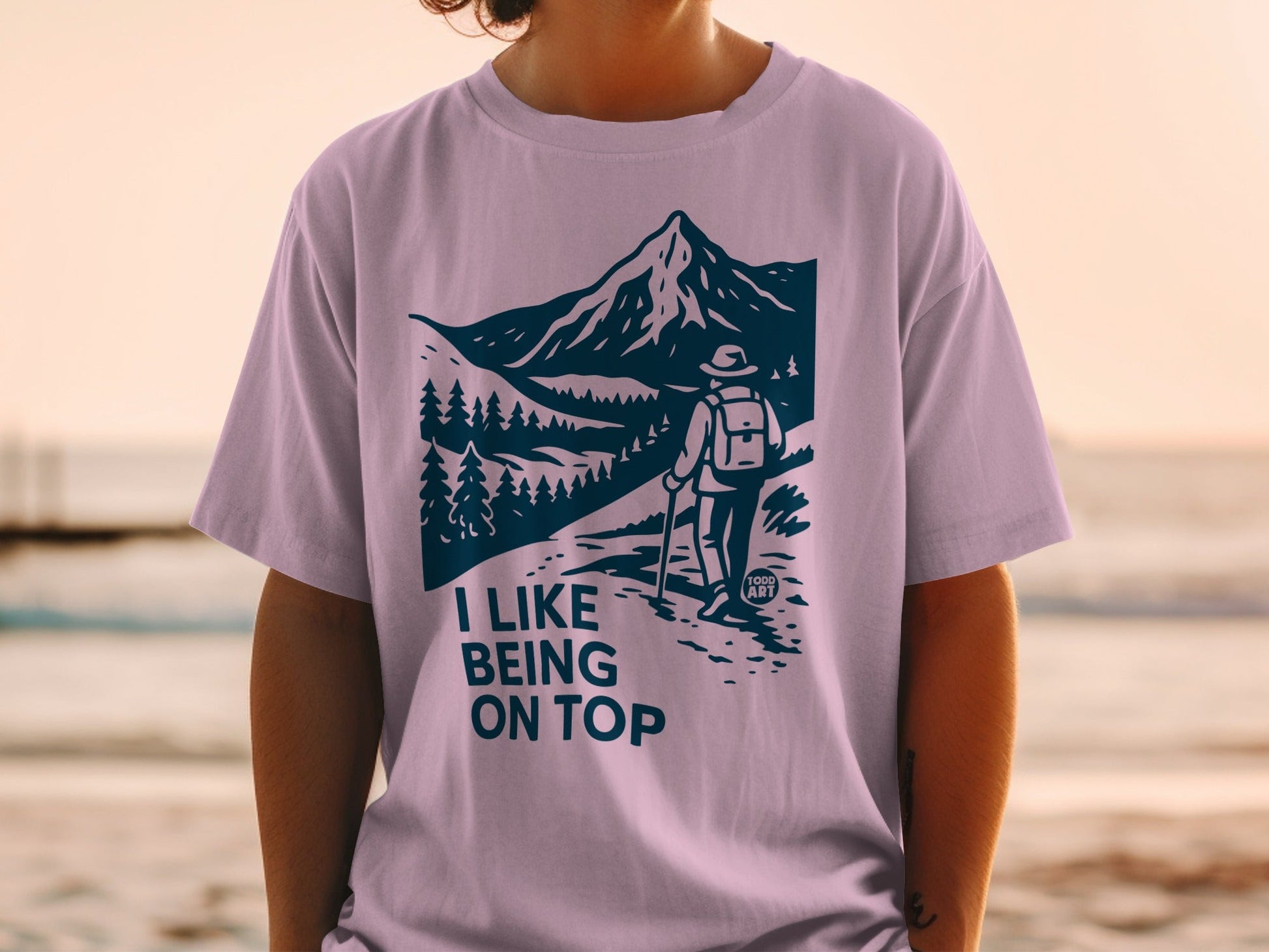 T-shirt with mountain landscape design and text "I LIKE BEING ON TOP".