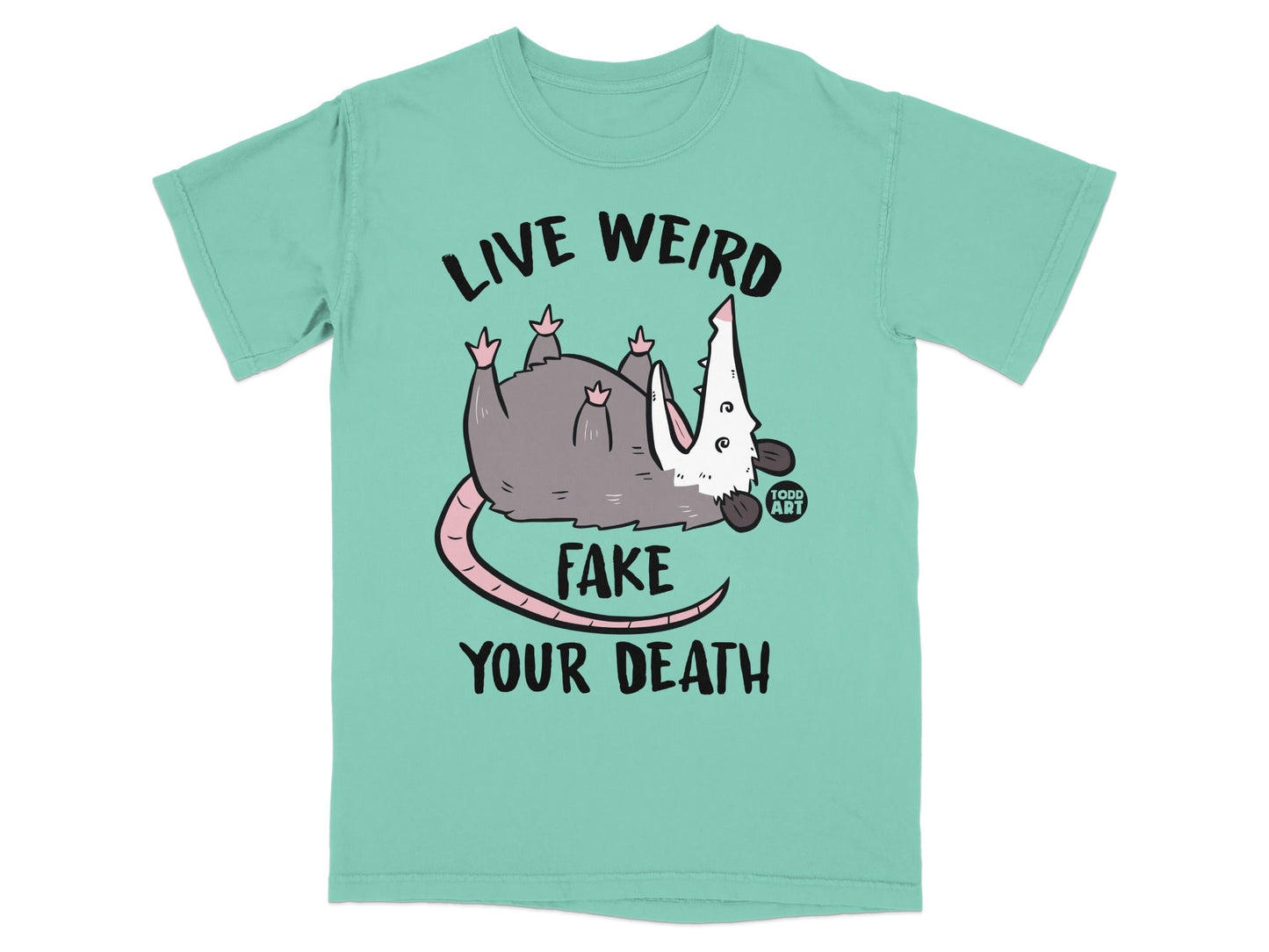 Opossum wearing shirt with "LIVE WEIRD FAKE YOUR DEATH" text.