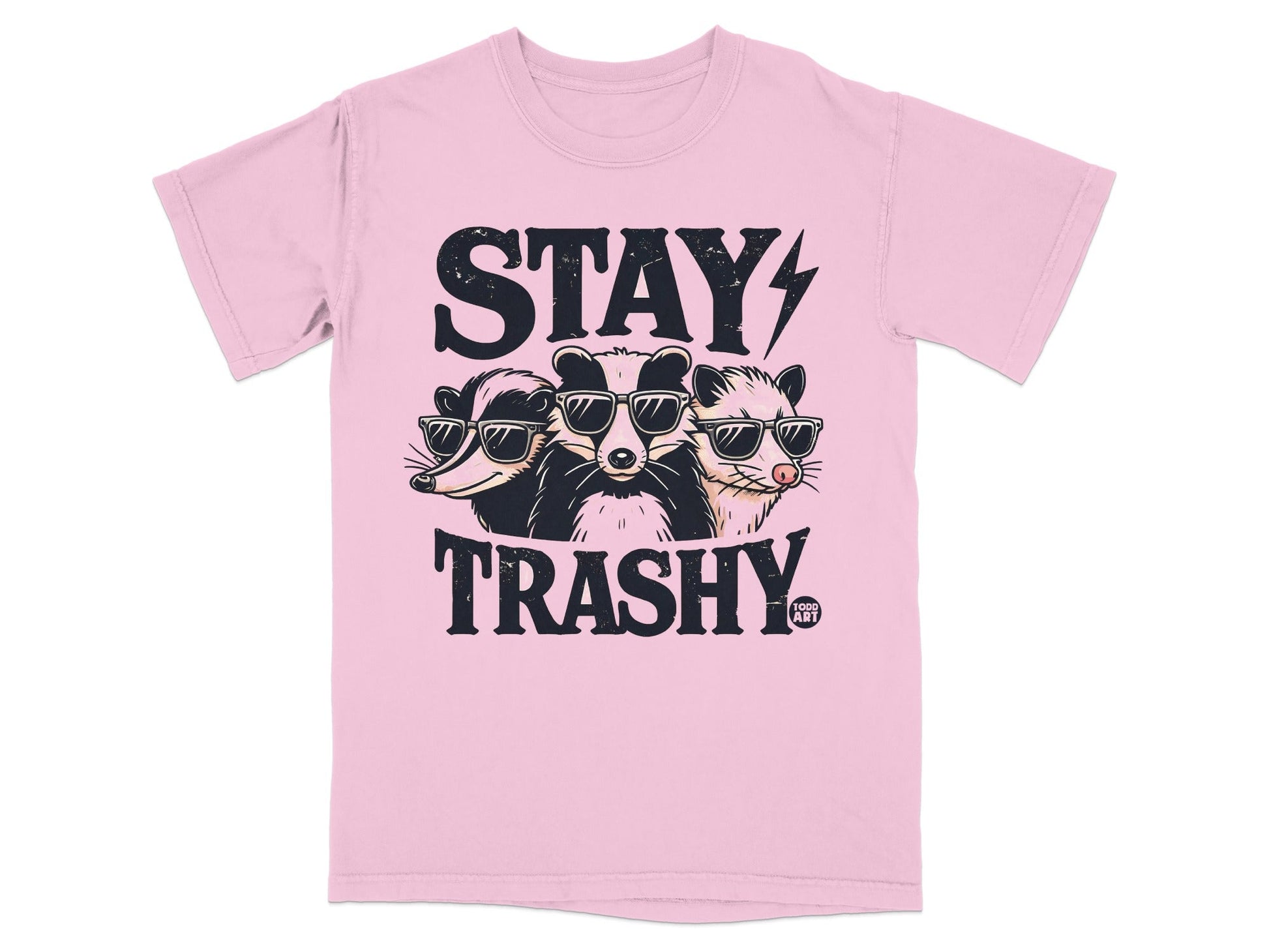 Pink t-shirt with "STAY TRASHY" and three raccoons wearing sunglasses.