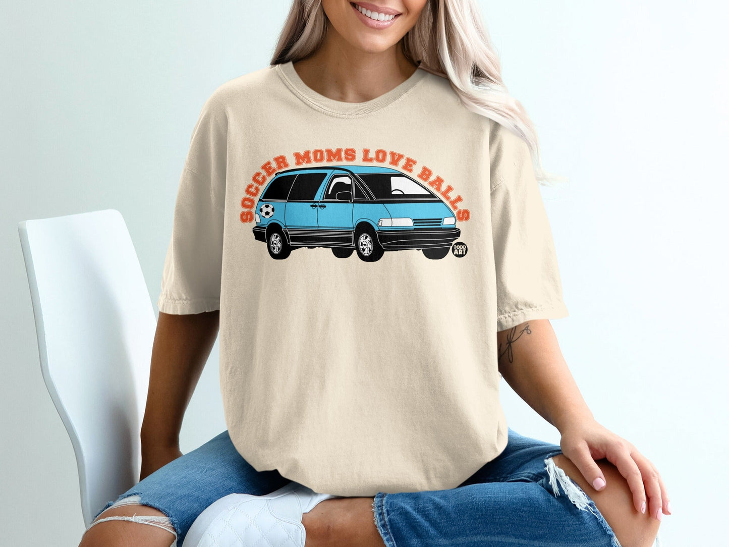 Light tan t-shirt with blue minivan and "Soccer Moms Love Balls" text.