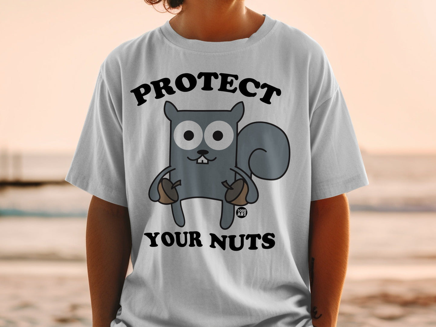 T-shirt with cartoon squirrel holding acorns, text "Protect Your Nuts."