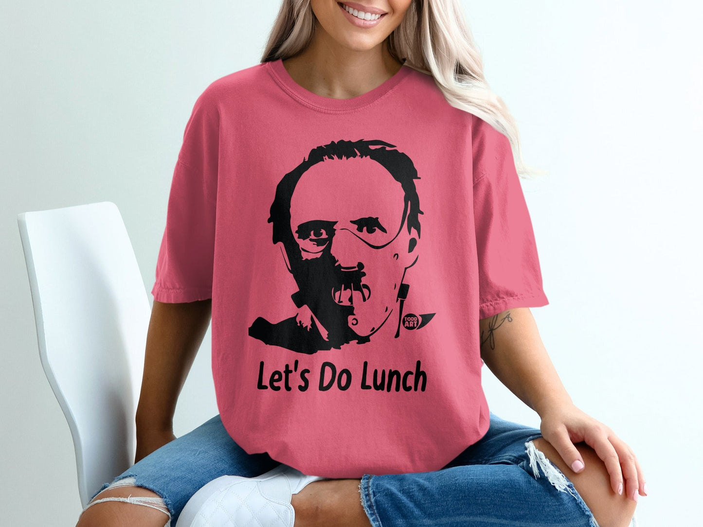 Pink t-shirt with Hannibal Lecter graphic and "Let's Do Lunch" text.