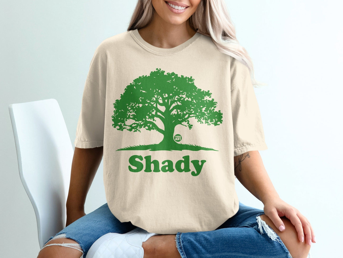 T-shirt with a green tree graphic and the word "Shady".
