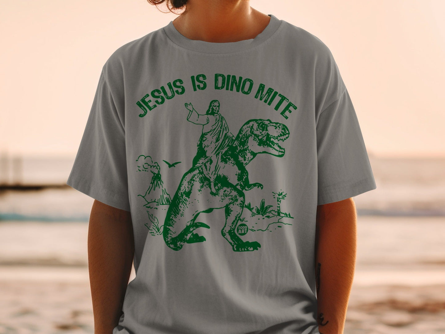 Jesus riding a dinosaur with "Jesus is Dino-Mite" text.