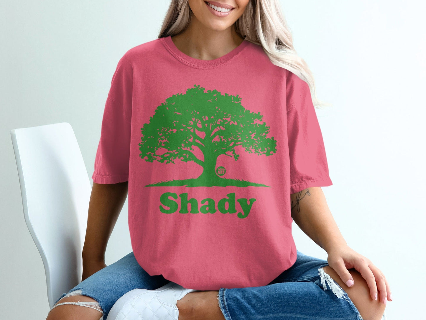 Coral t-shirt with green tree graphic and "Shady" text.
