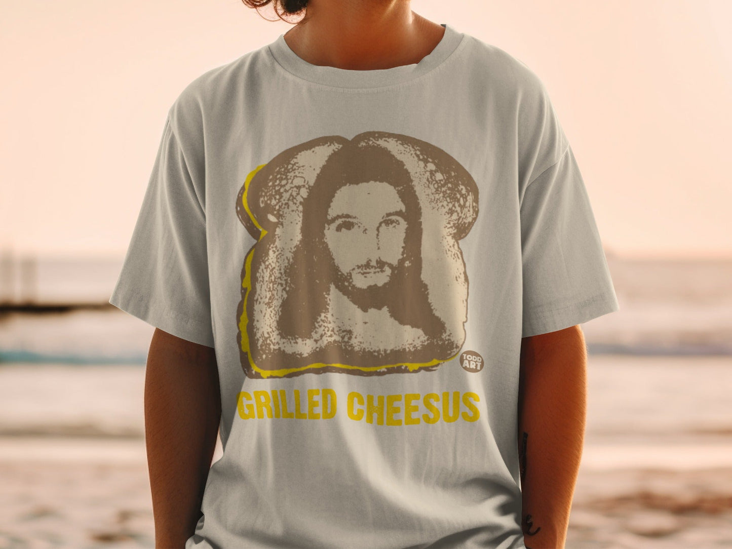 T-shirt with "Grilled Cheesus" text and Jesus on toast graphic.