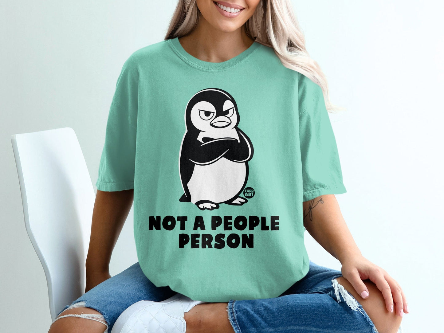 Mint green t-shirt with a grumpy penguin and "NOT A PEOPLE PERSON" text.