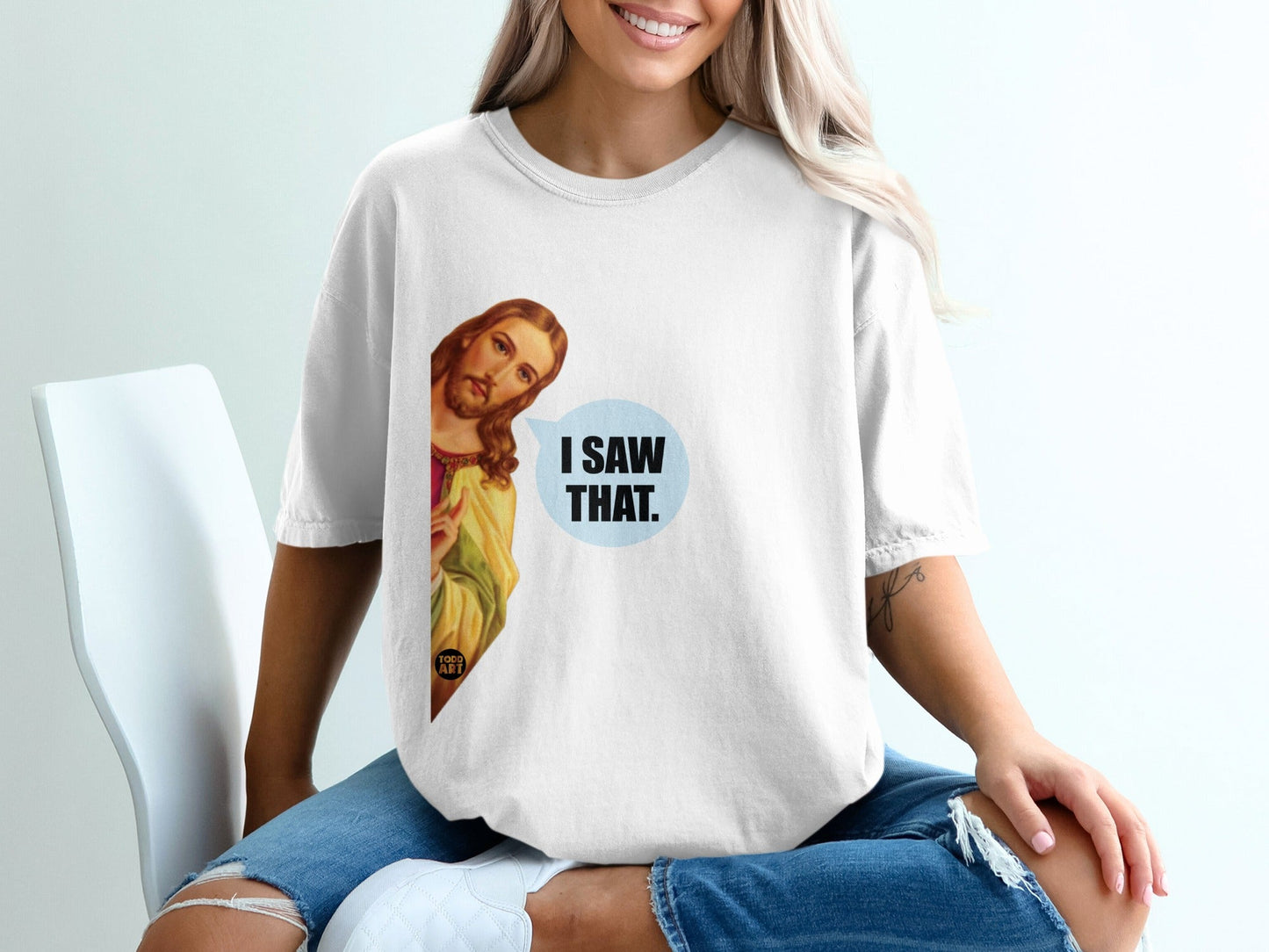 White t-shirt with Jesus peeking and saying "I saw that."