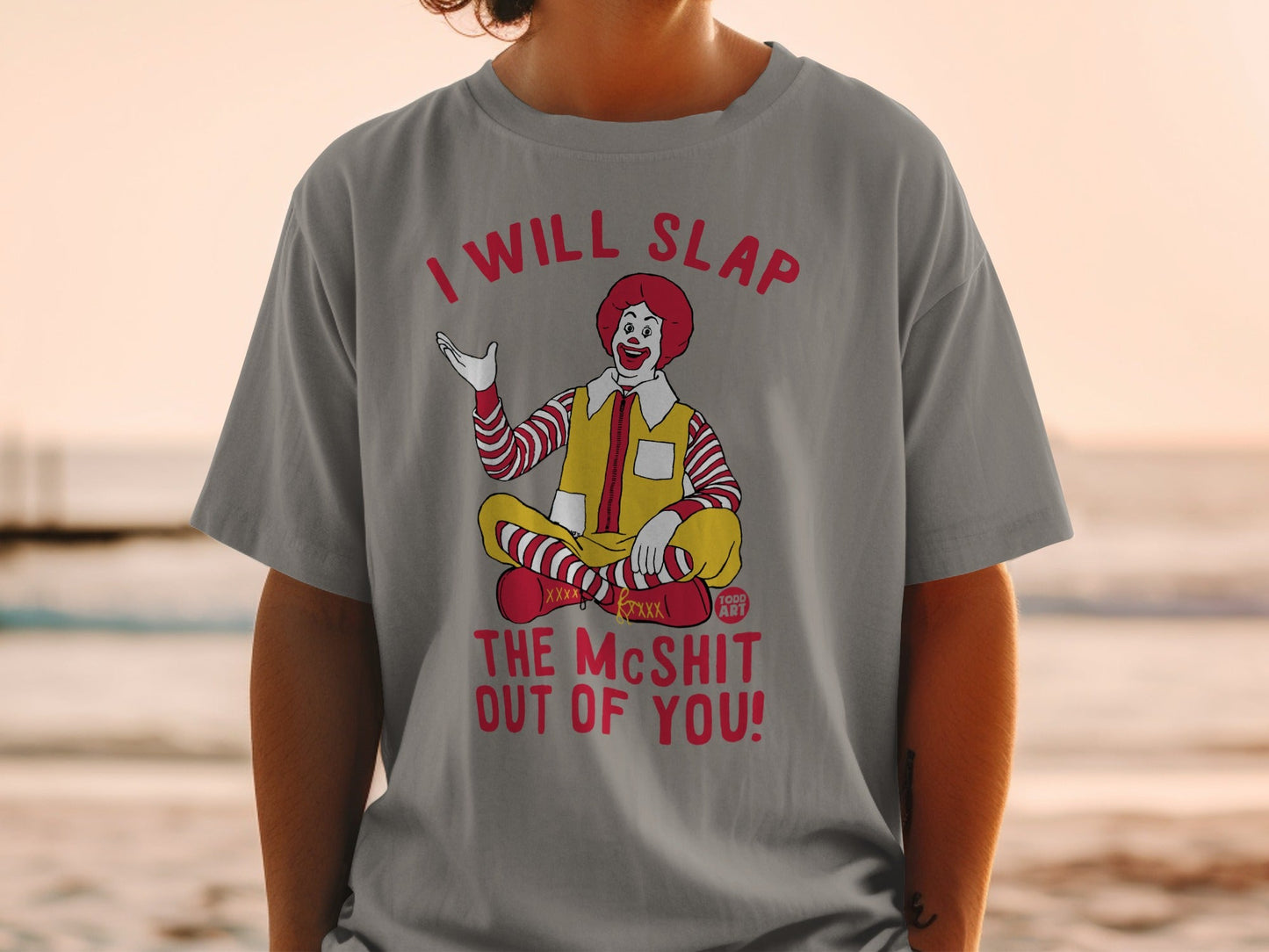 Grimace character in a t-shirt with red text.