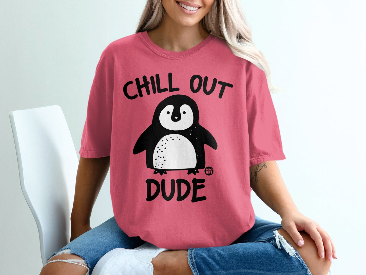 Pink t-shirt with "Chill Out Dude" and a cartoon penguin graphic.