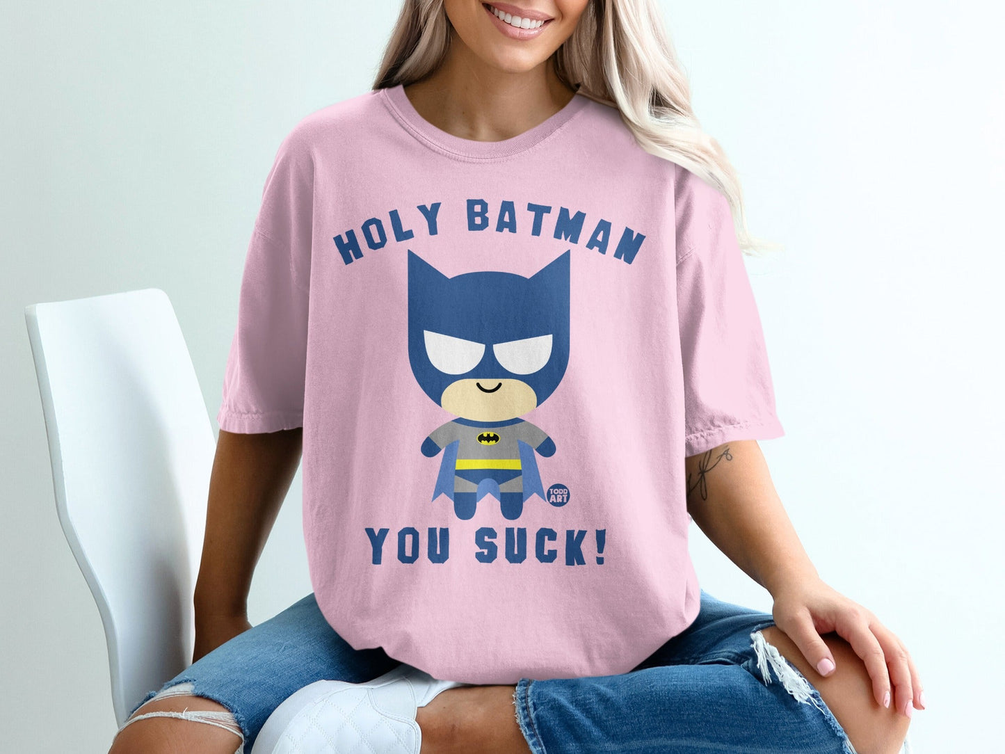 Pink t-shirt with "Holy Batman, You Suck!" graphic.