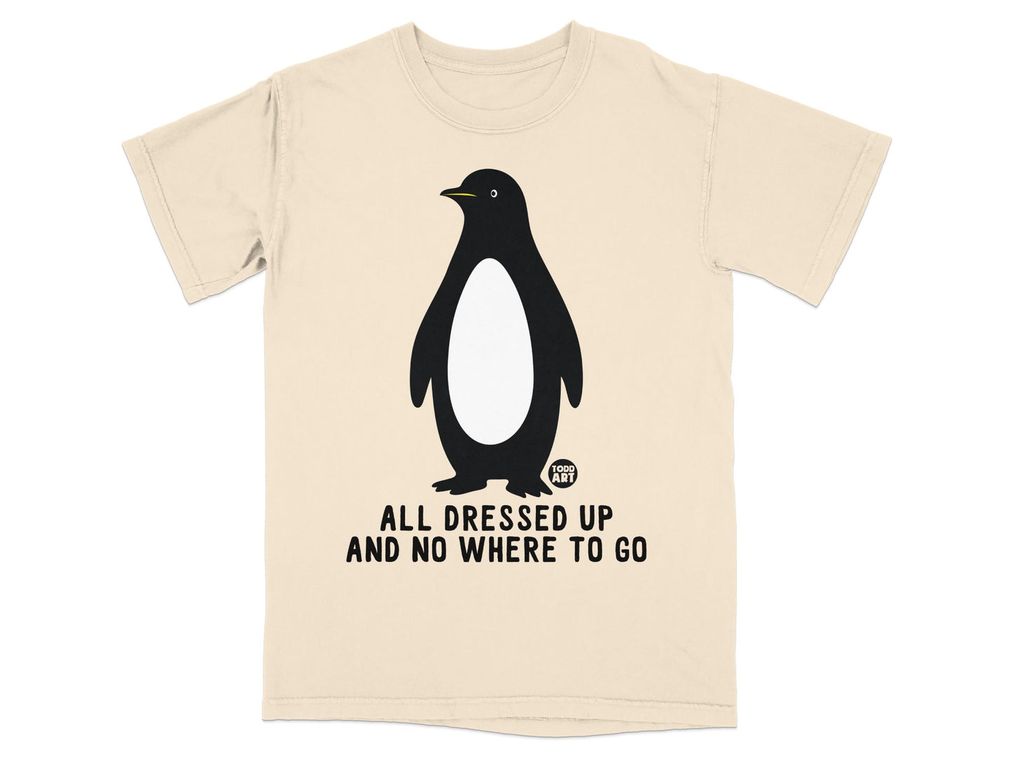 T-shirt with black penguin graphic and text "ALL DRESSED UP AND NO WHERE TO GO".