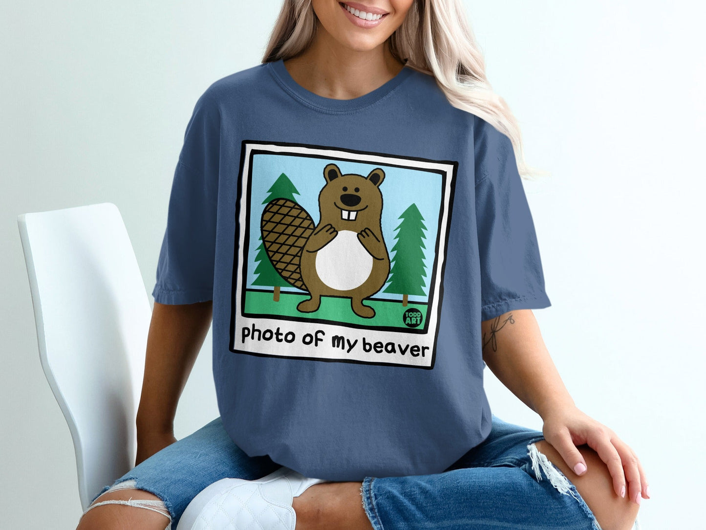 Cartoon beaver with trees and text "Photo of my beaver" on shirt.