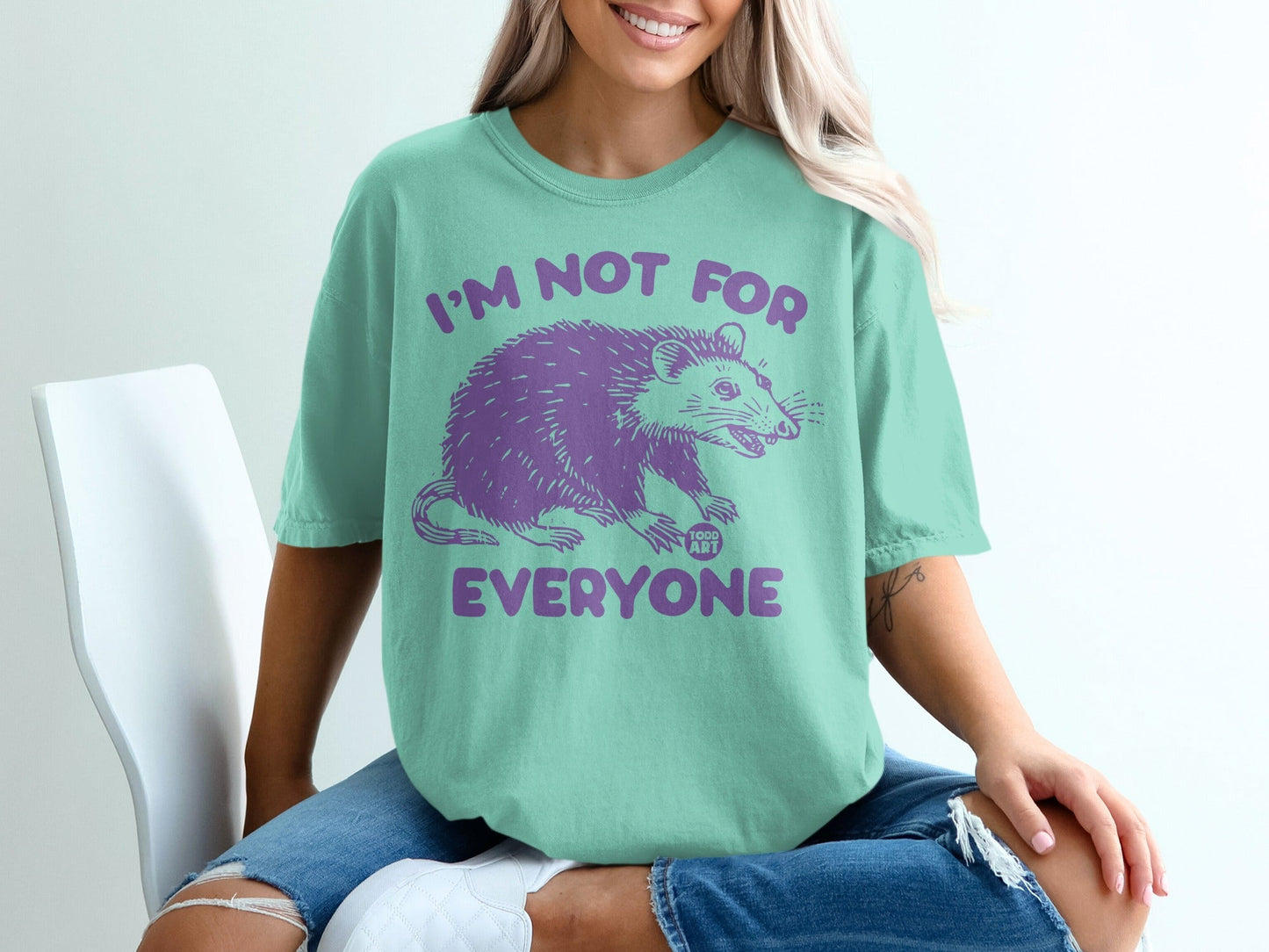 Mint t-shirt with purple possum graphic and text "I'M NOT FOR EVERYONE".