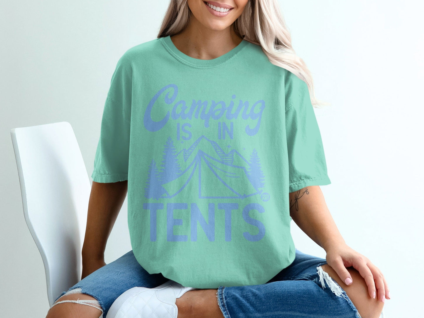 Mint green t-shirt with "Camping is in TENTS" text and tent graphic.
