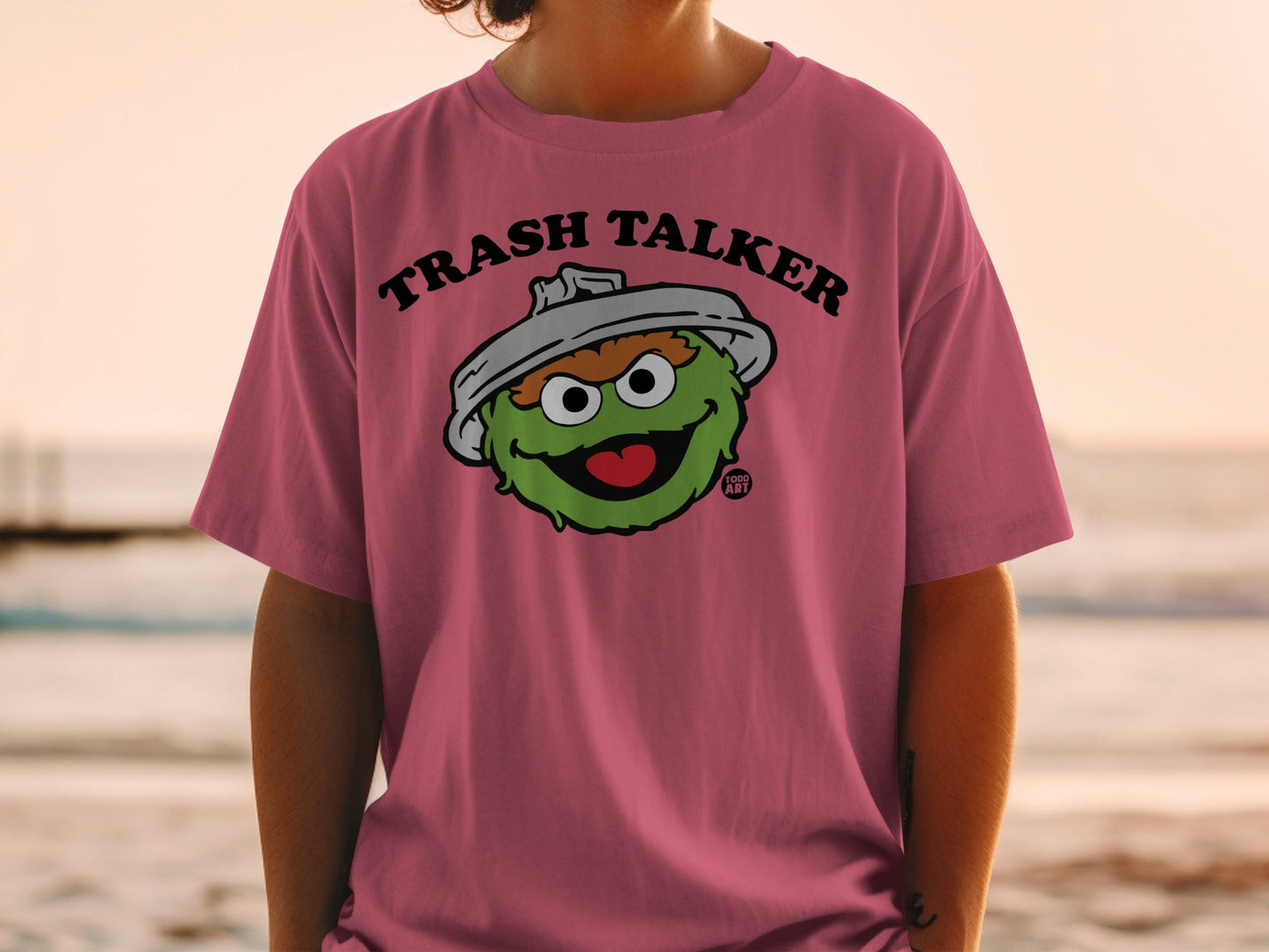 Pink t-shirt with Oscar the Grouch from Sesame Street saying "Trash Talker".
