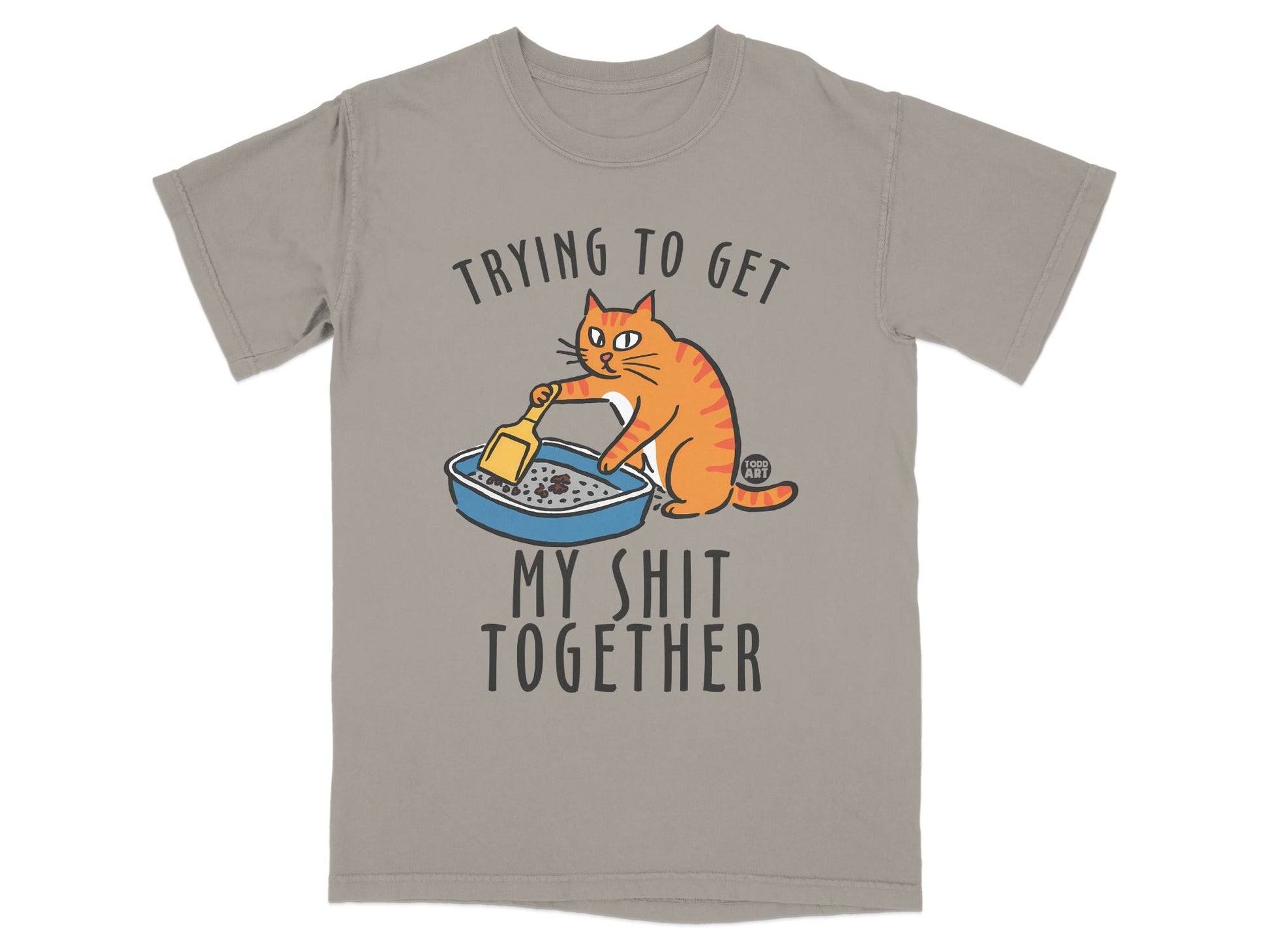 Orange cat cleaning a litter box with text "Trying to get my shit together".