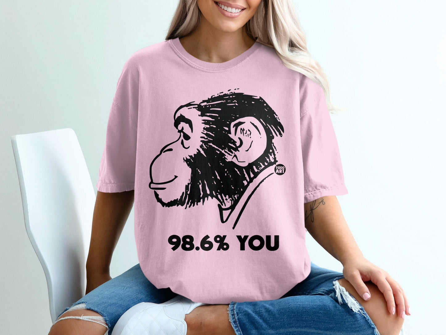 Pink t-shirt with black monkey graphic and "98.6% YOU" text.