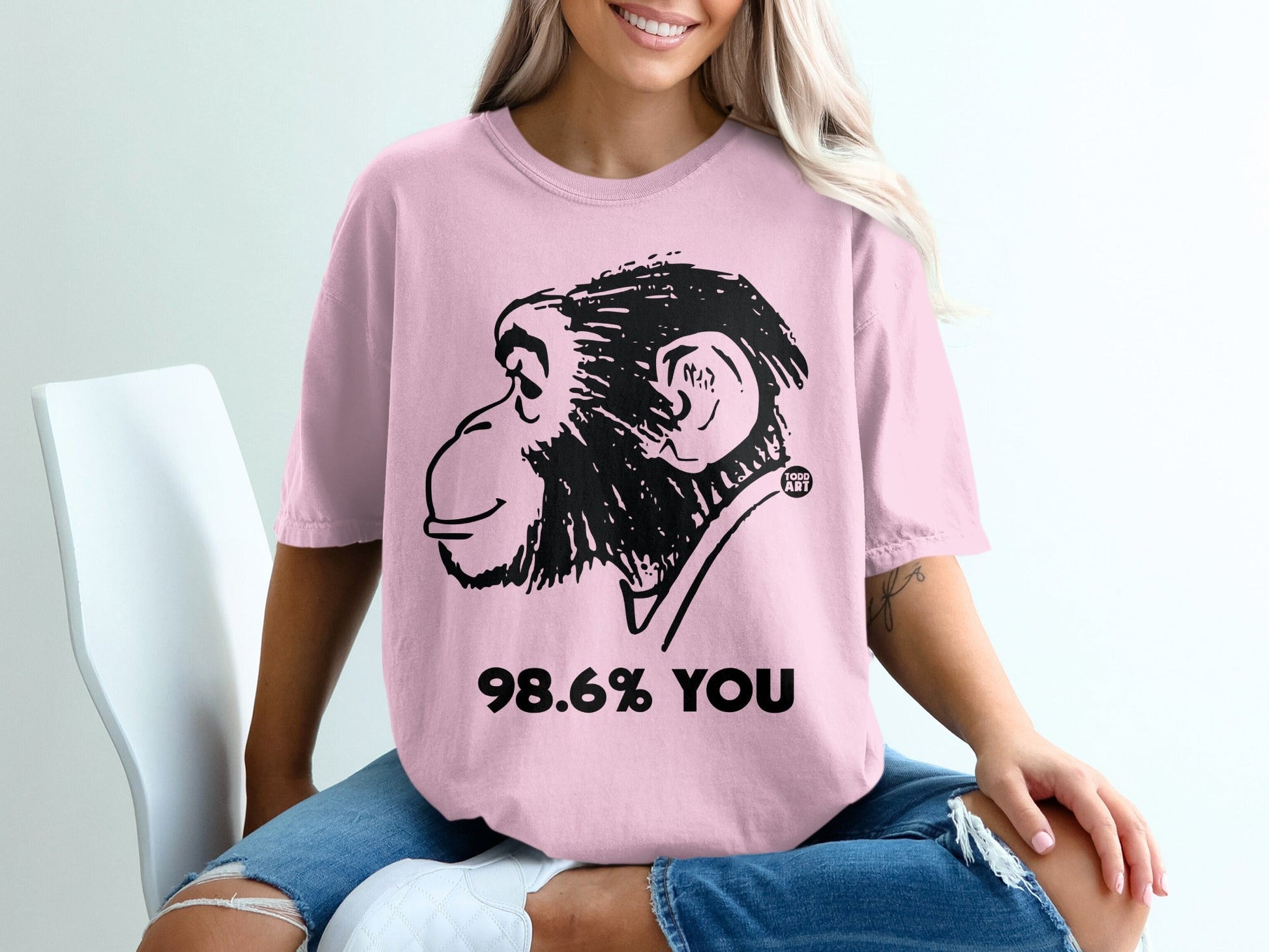 Pink t-shirt with black monkey graphic and "98.6% YOU" text.