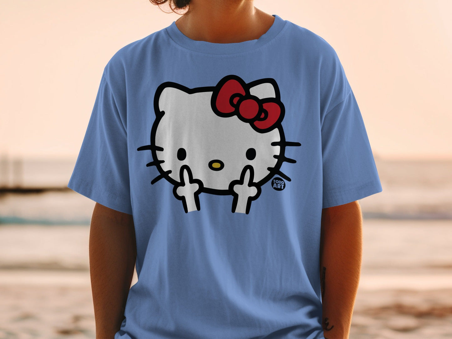 Blue t-shirt with Hello Kitty flipping the bird and "1000 ART" logo.