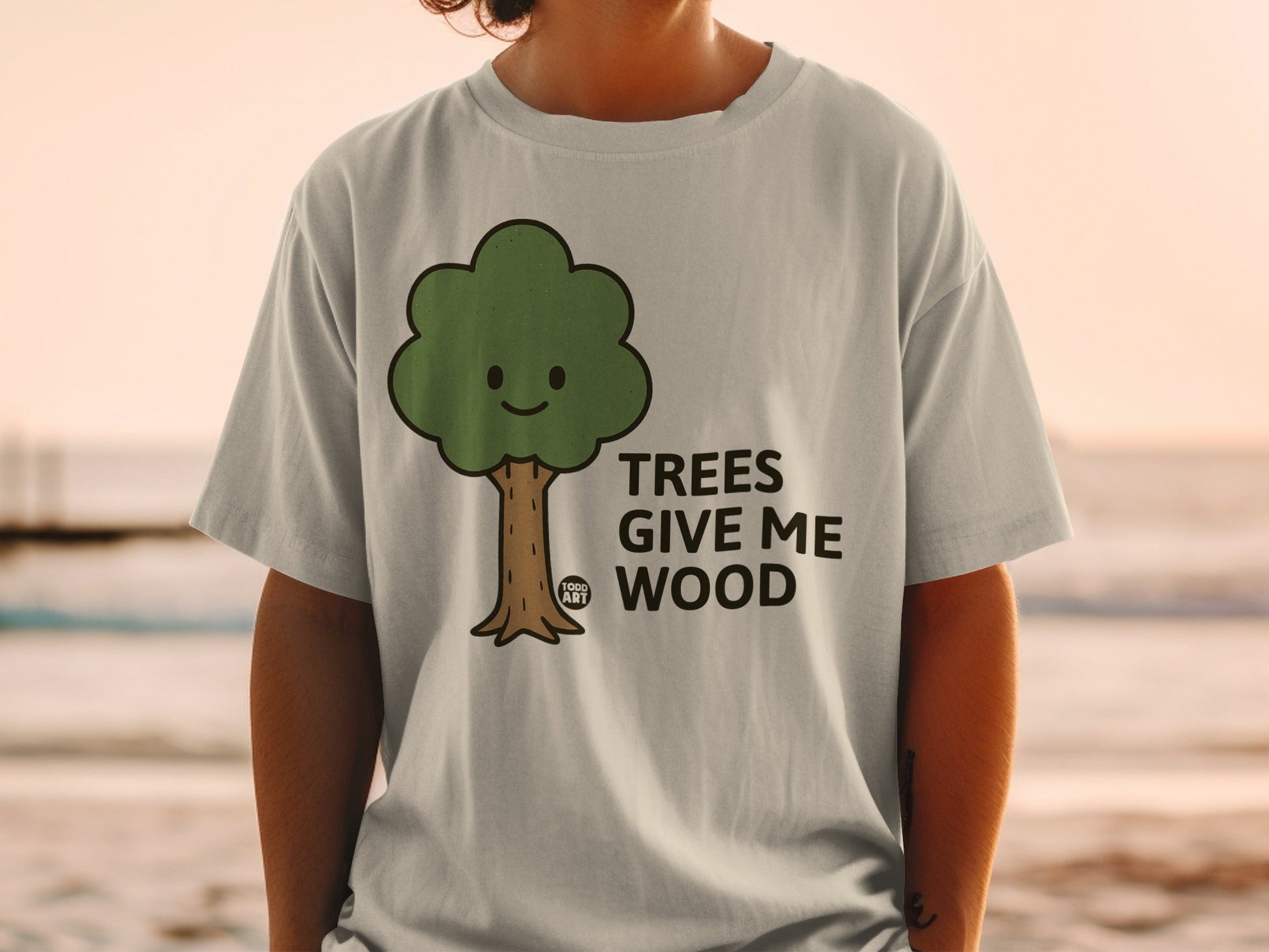 T-shirt with cartoon tree graphic and text "TREES GIVE ME WOOD".